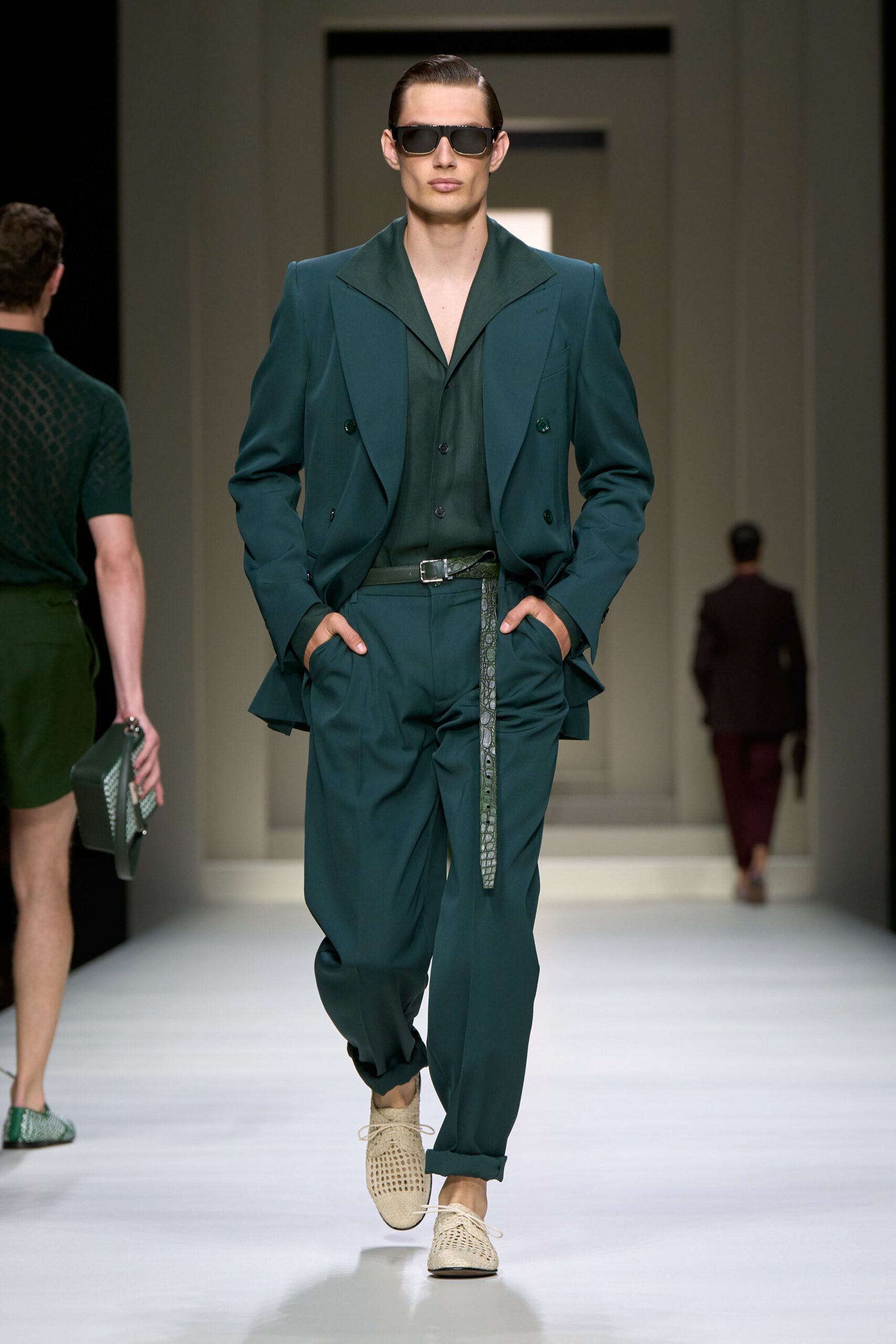 green tailored suit with sunglasses