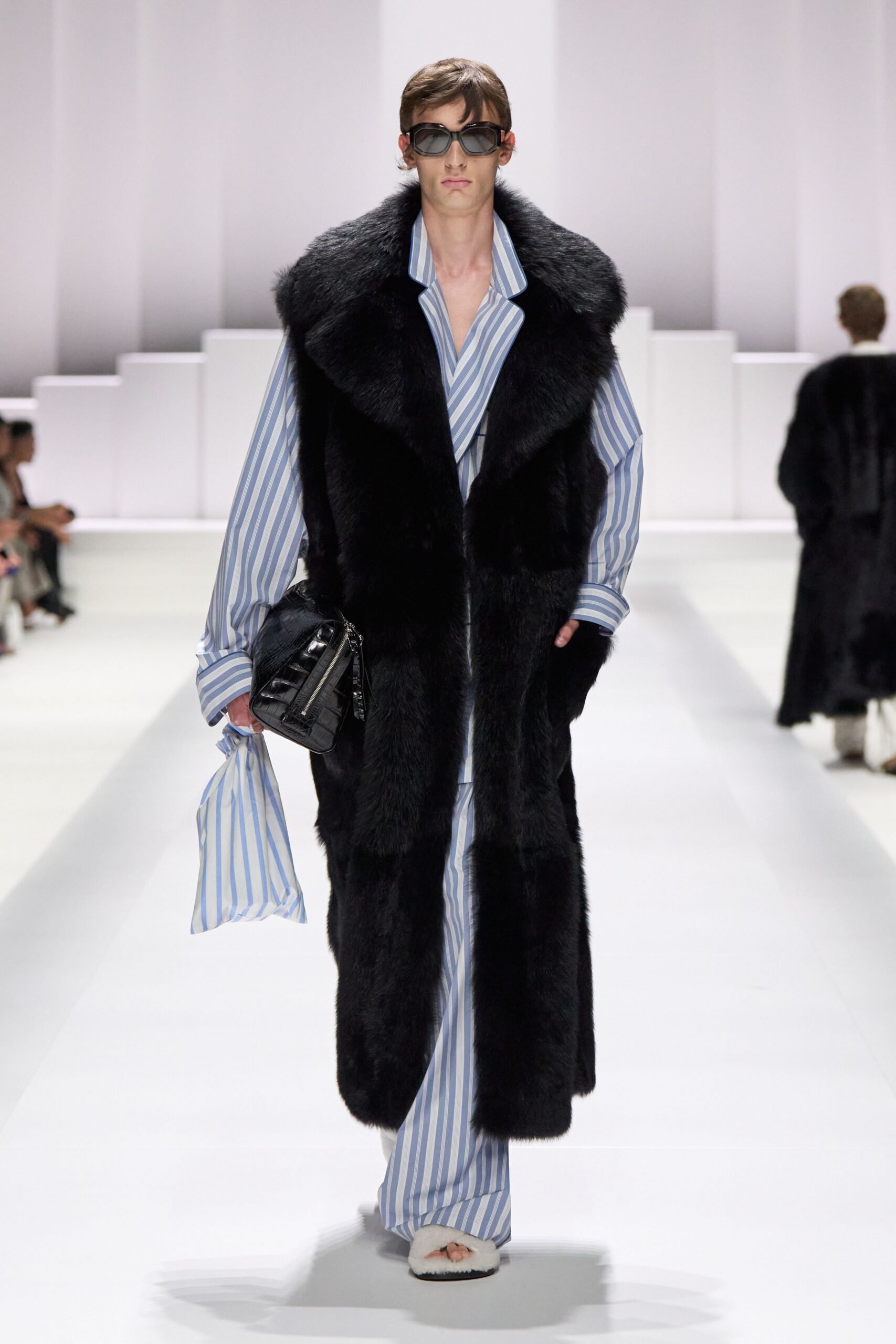 black faux-fur coat with striped shirt and pants