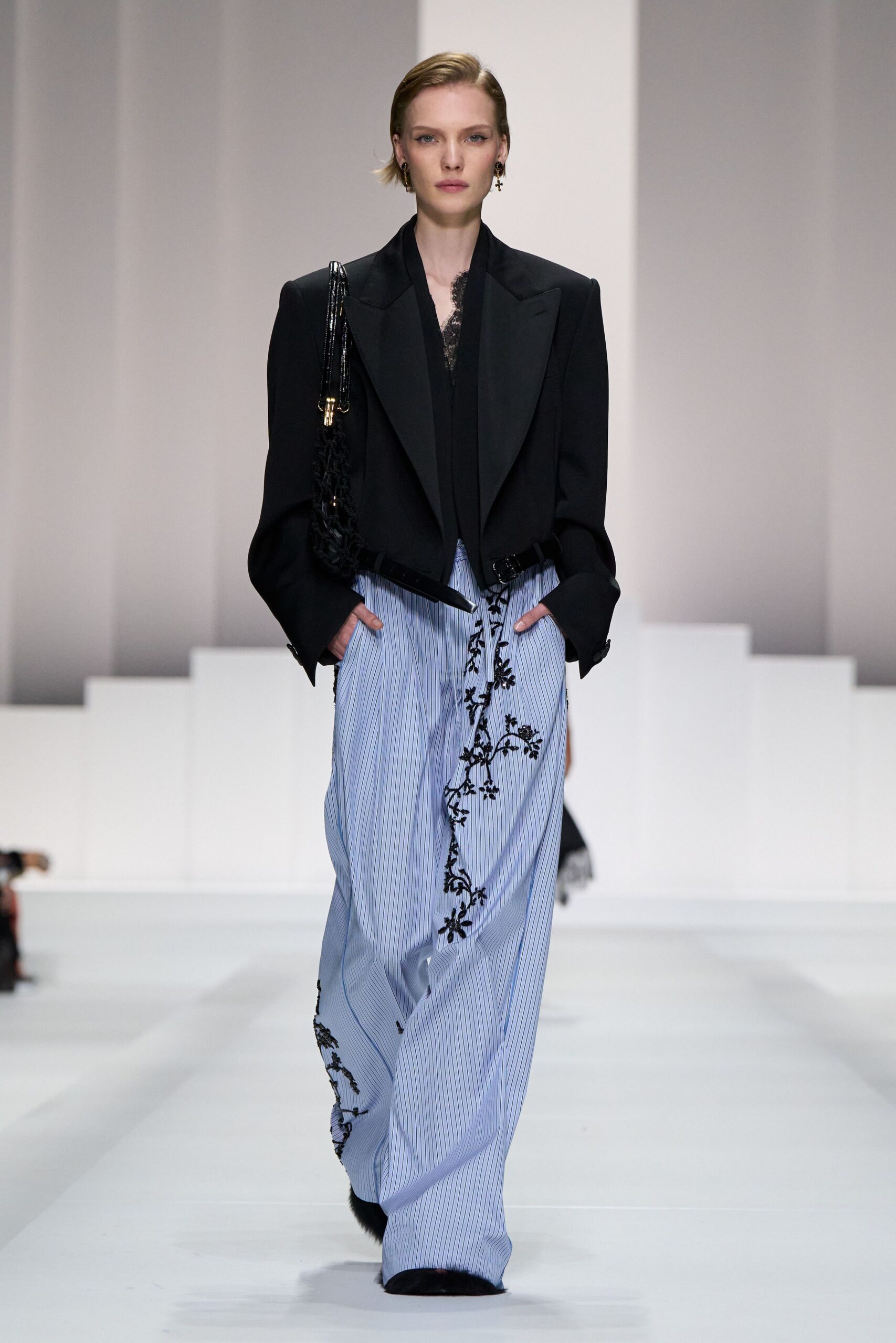 black blazer and blue pleated pants