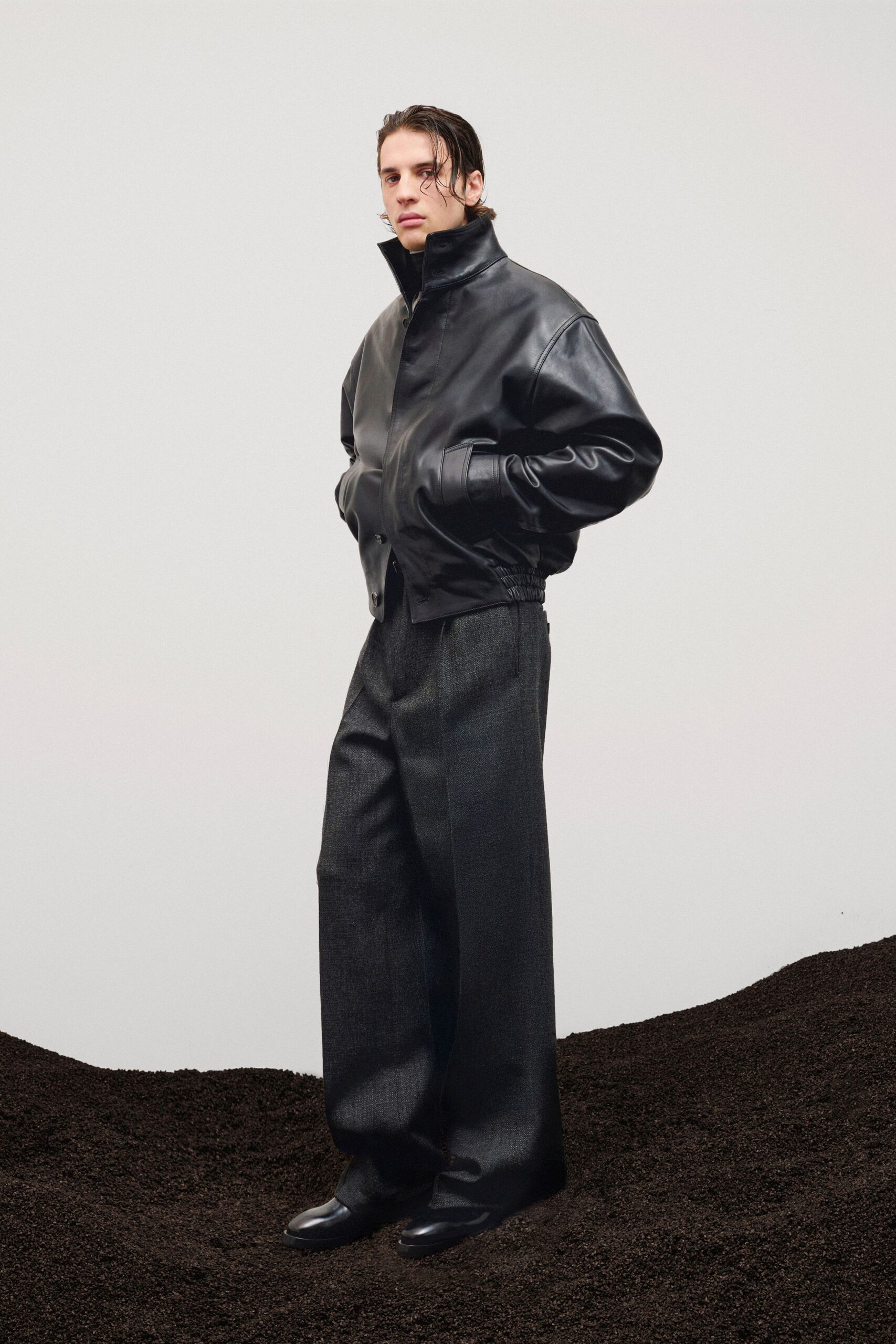 black leather jacket with gray pants