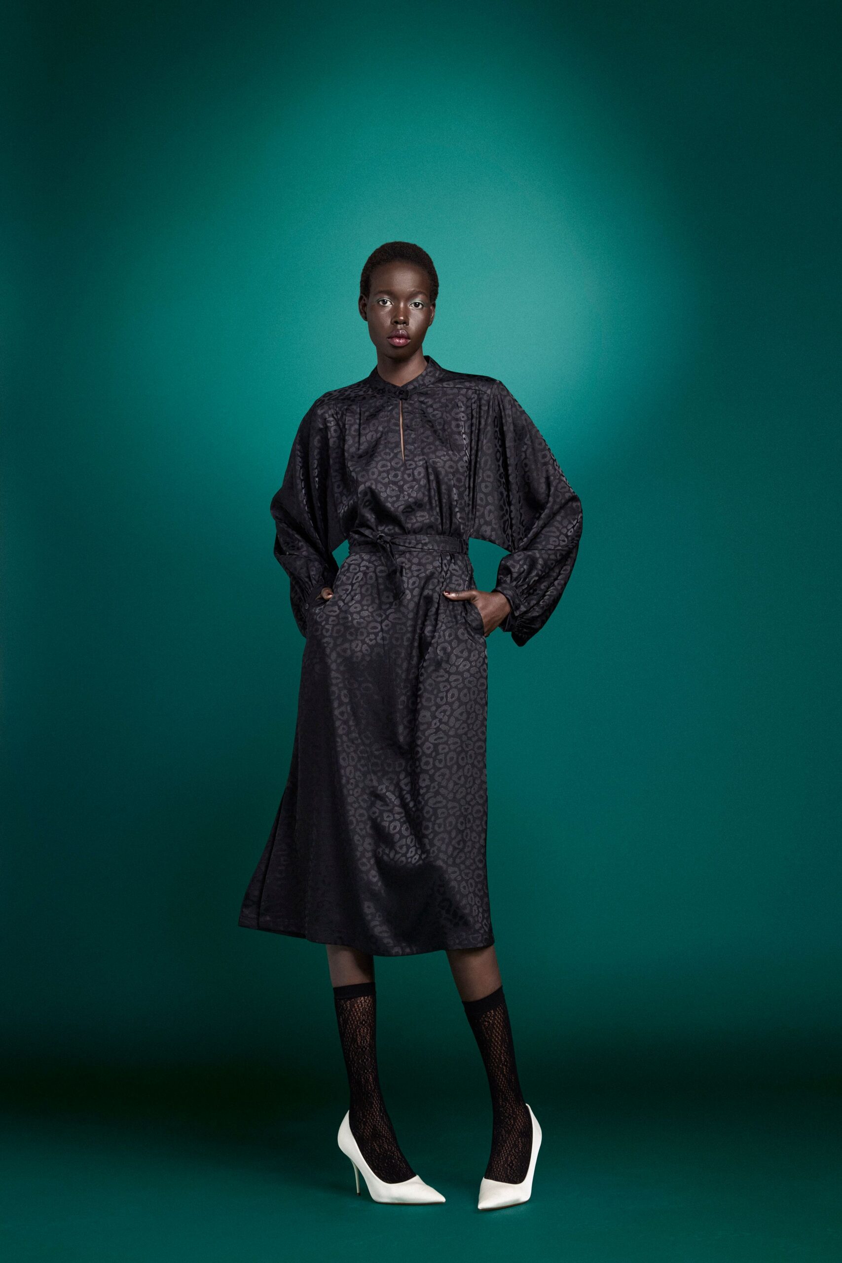 black silk pleated midi dress with white shoes