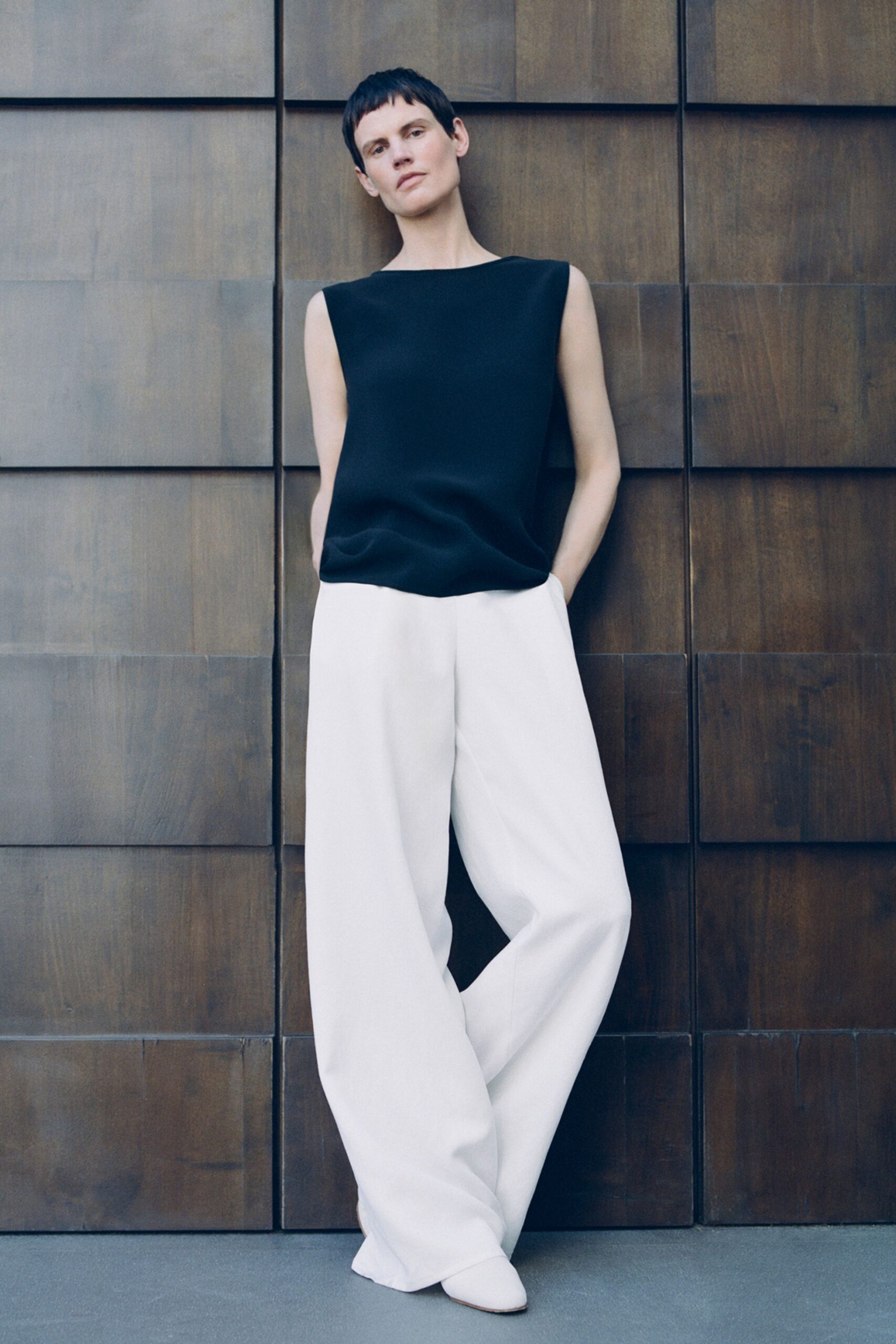 black silk sleeveless high-neck relaxed top