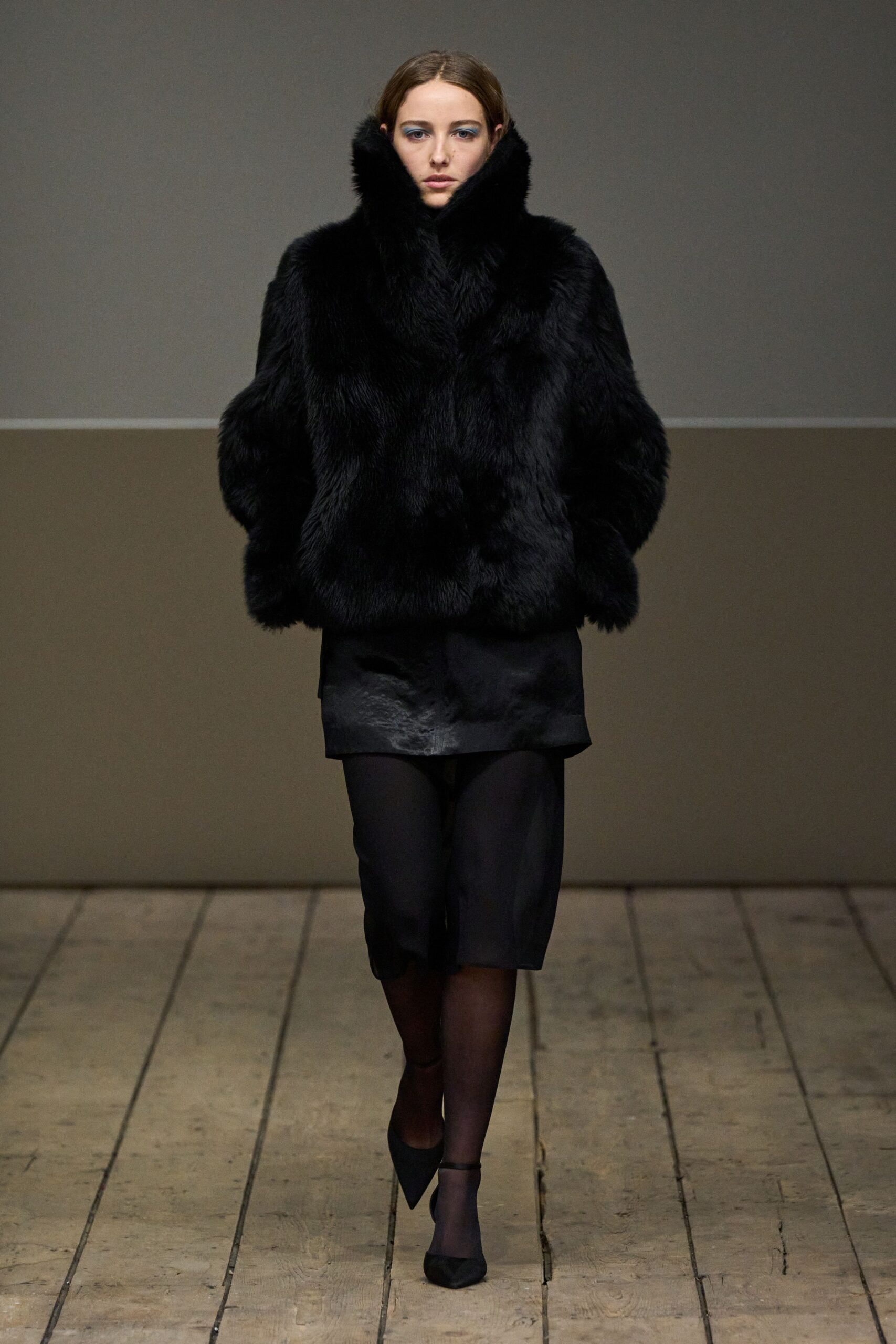 black faux-fur coat with mini skirt