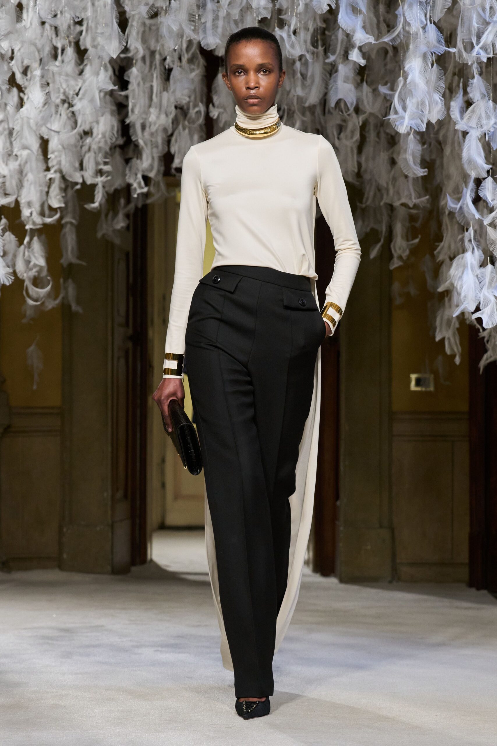 beige fitted top with black tailored pants