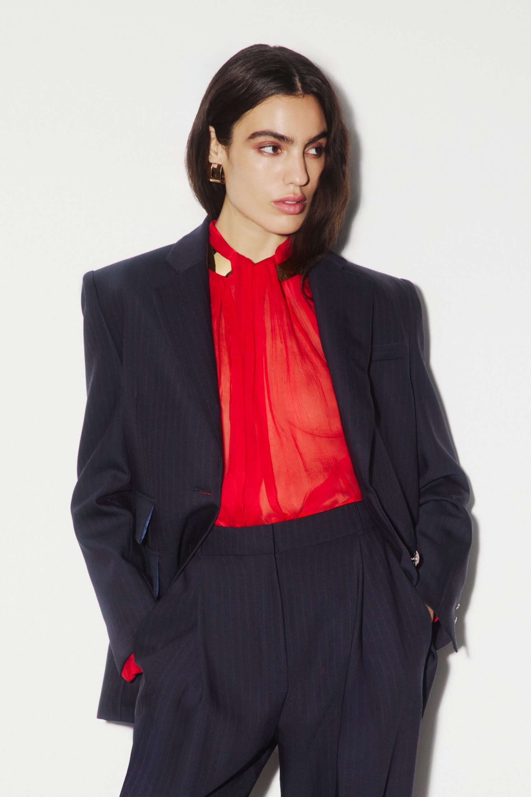 red long-sleeve high-neck fitted pleated blouse