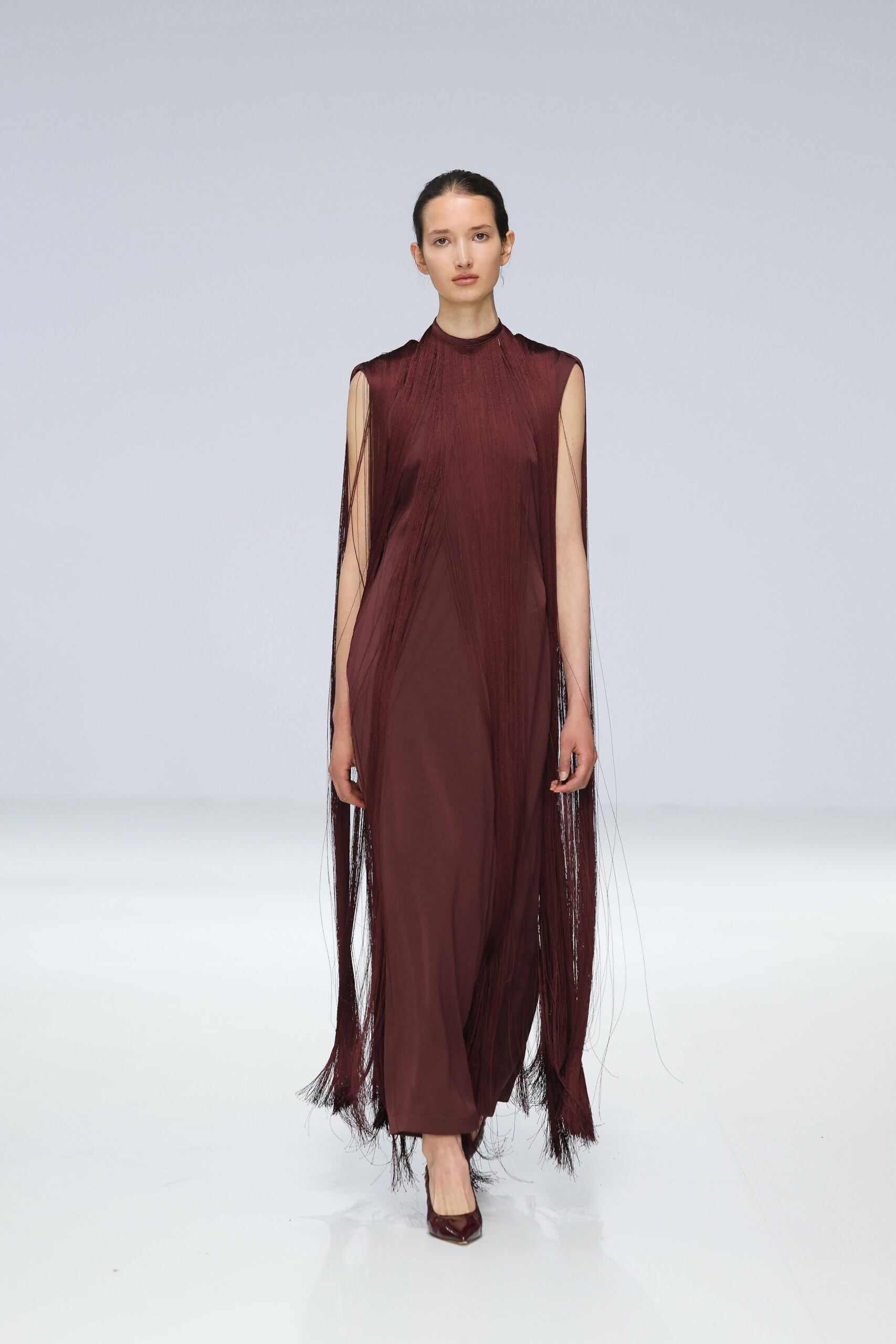 maroon silk sleeveless high-neck fitted fringed flowing gown