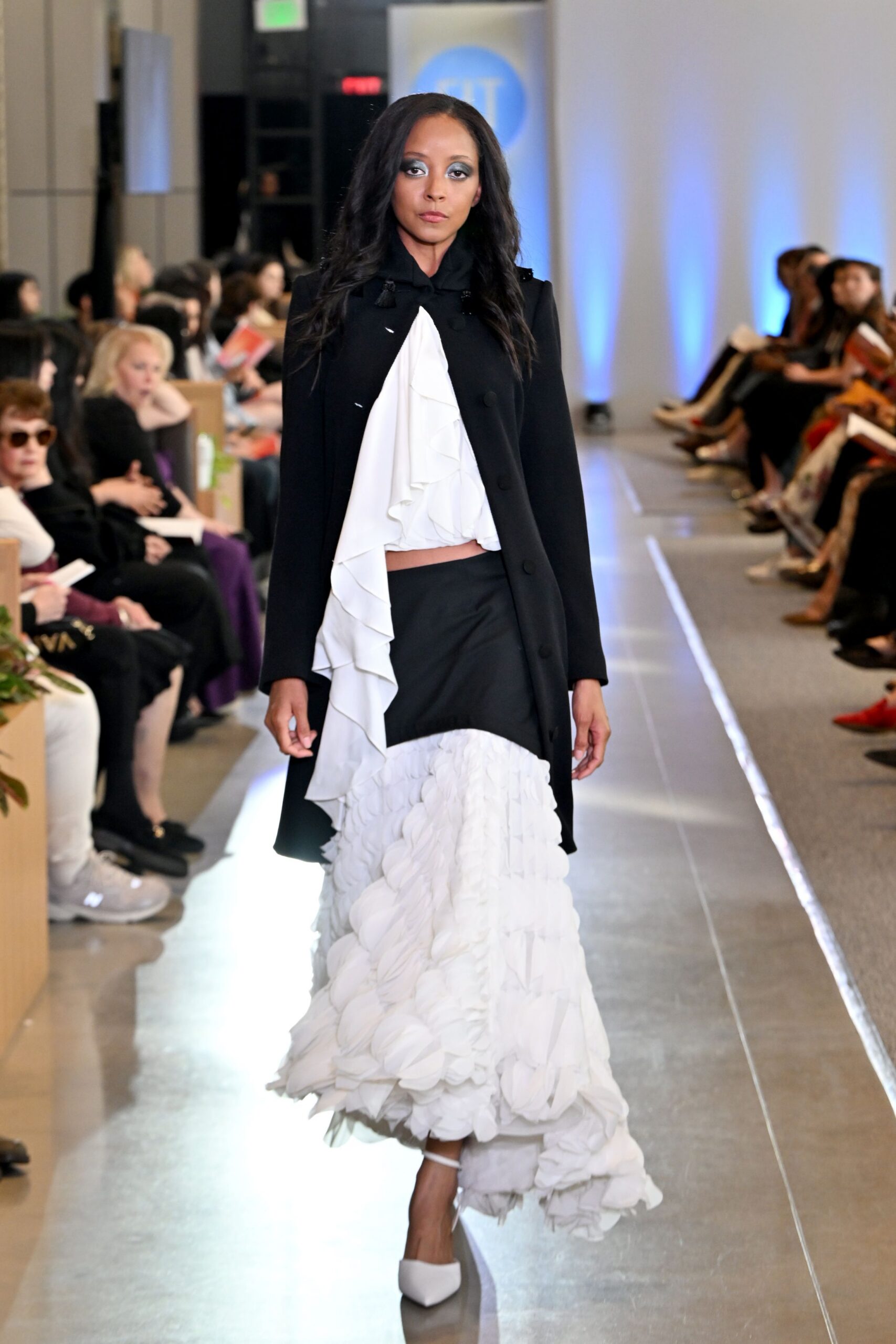 black coat white ruffled blouse