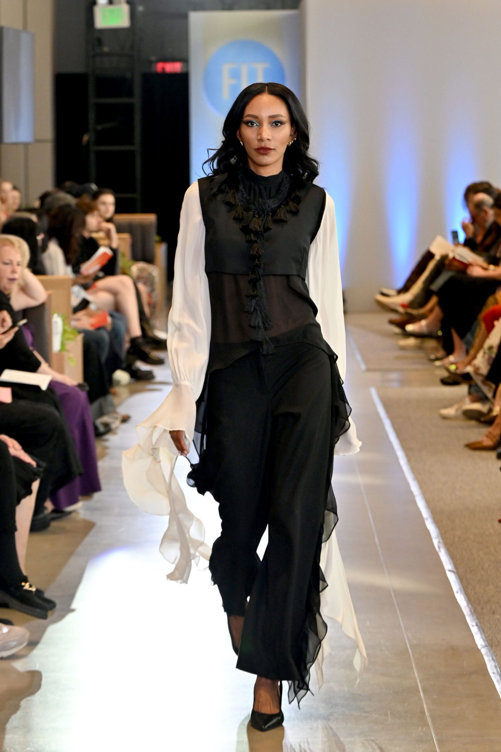 black and white ruffled blouse with flared pants