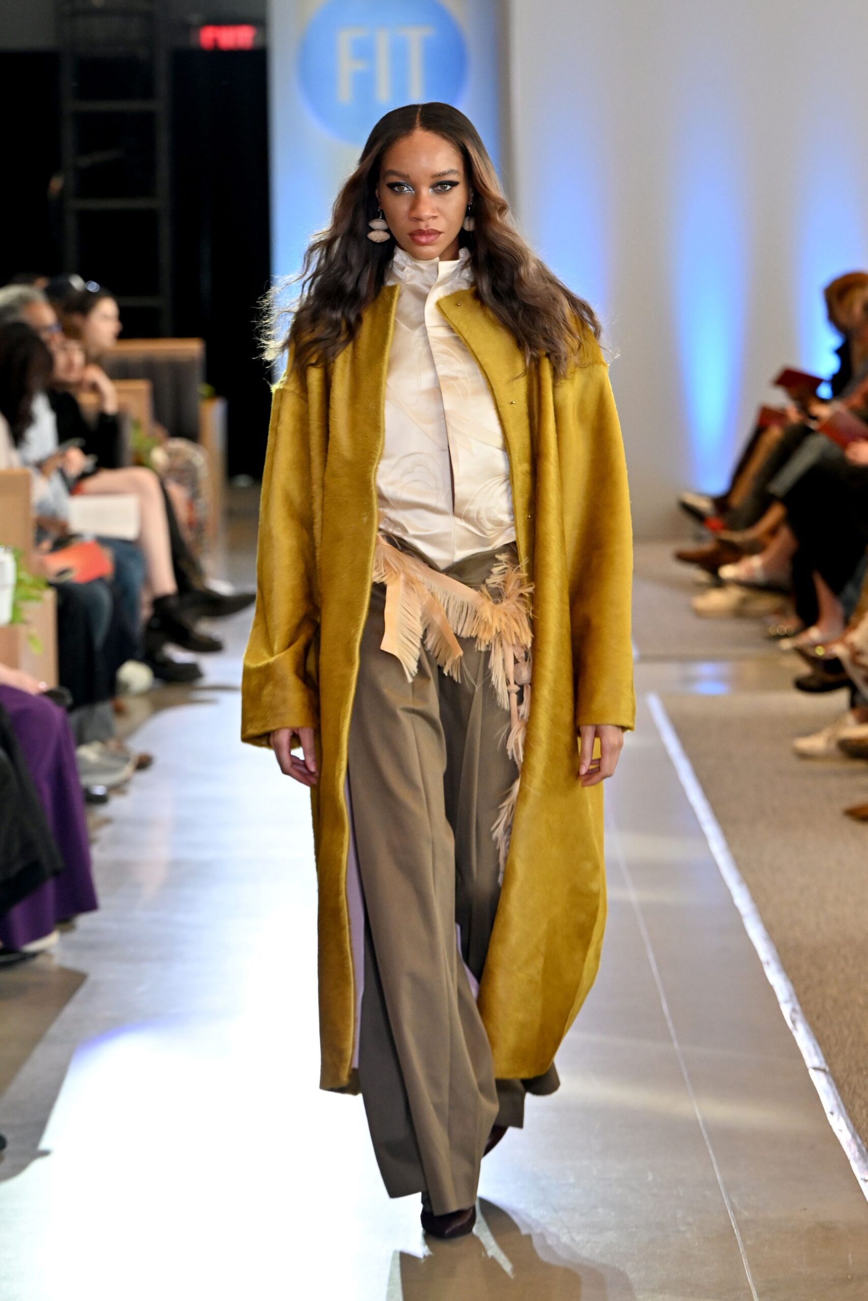 yellow fur coat with white shirt and gray pants