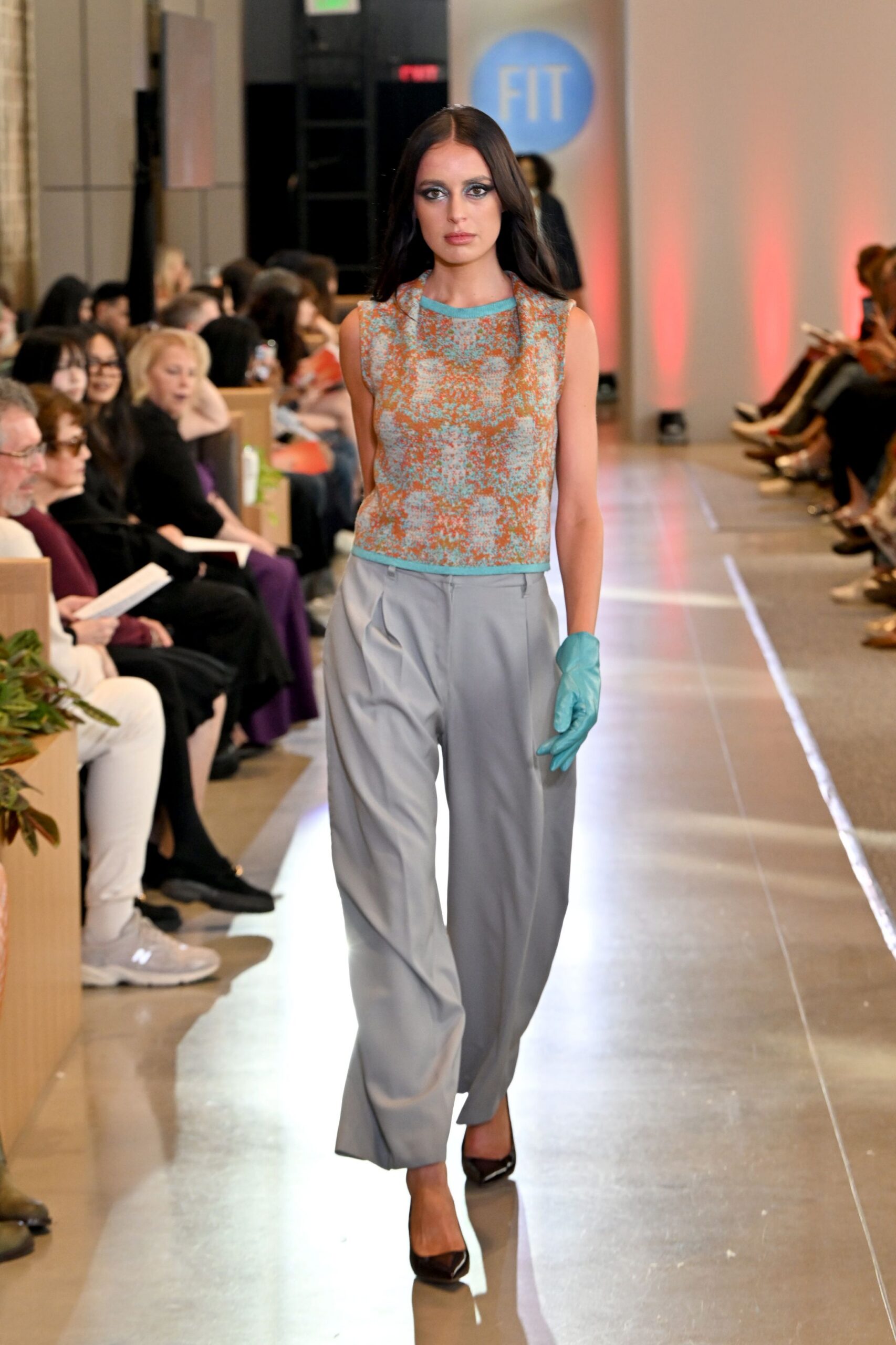 blue embroidered sleeveless top with gray pants