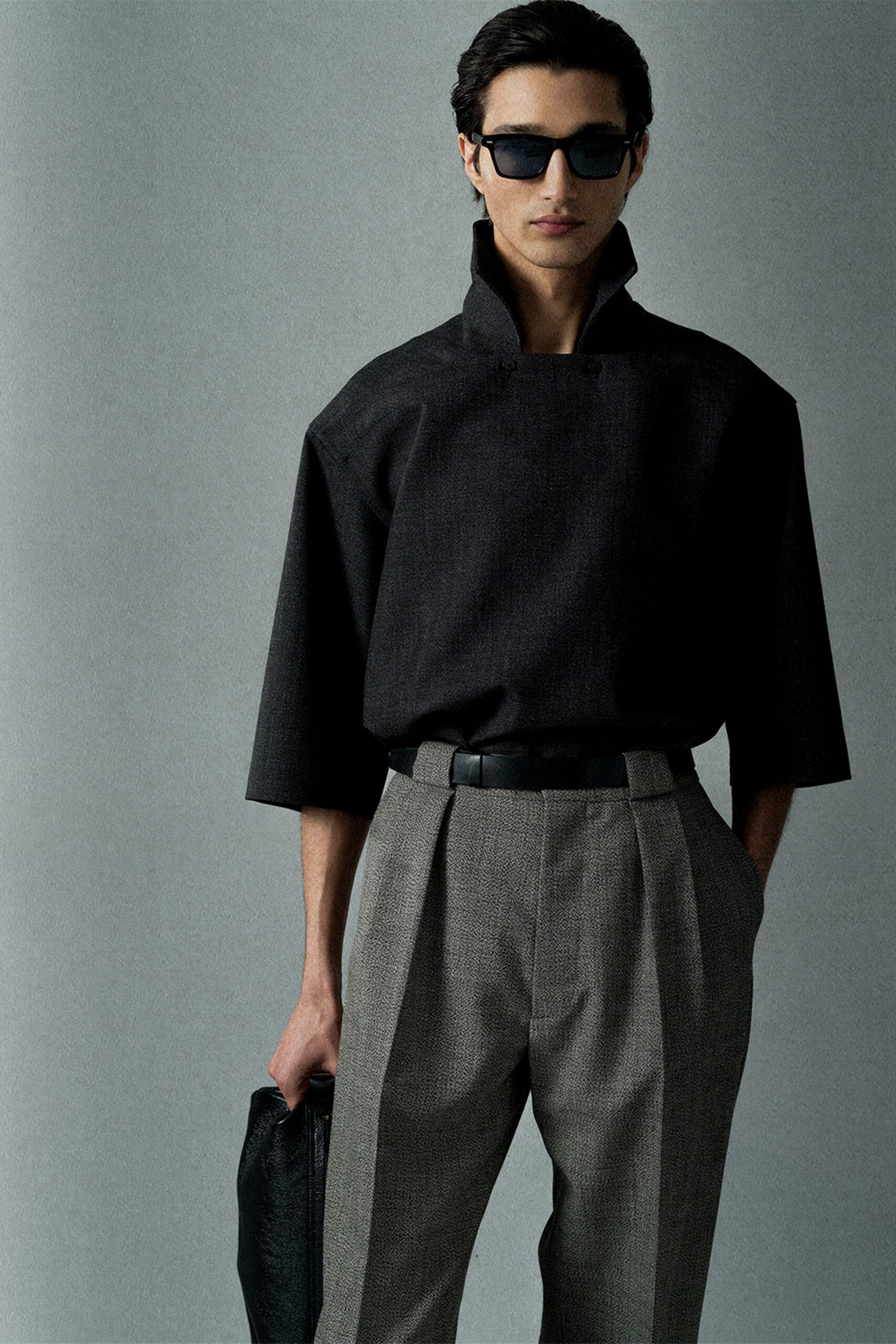 black relaxed top with gray tailored pants