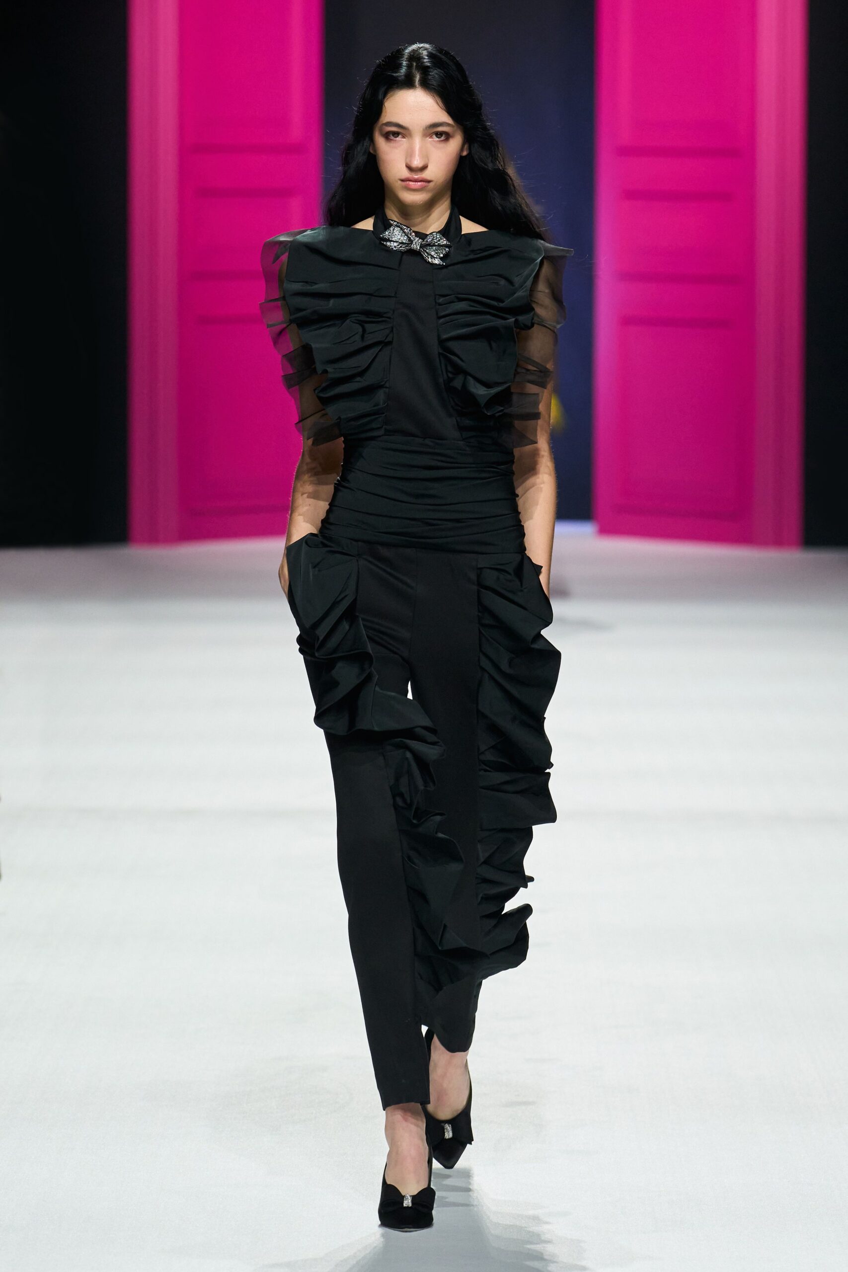 black ruffled jumpsuit with heels