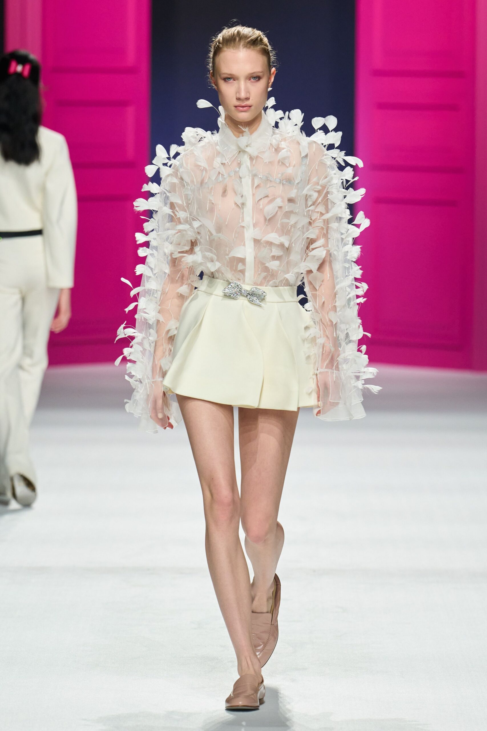 white ruffled blouse with beige shorts