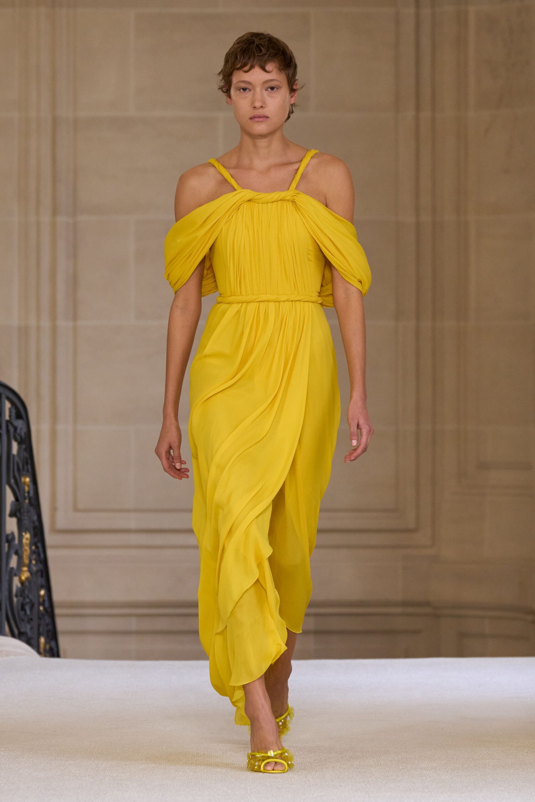 yellow pleated midi dress with gold shoes