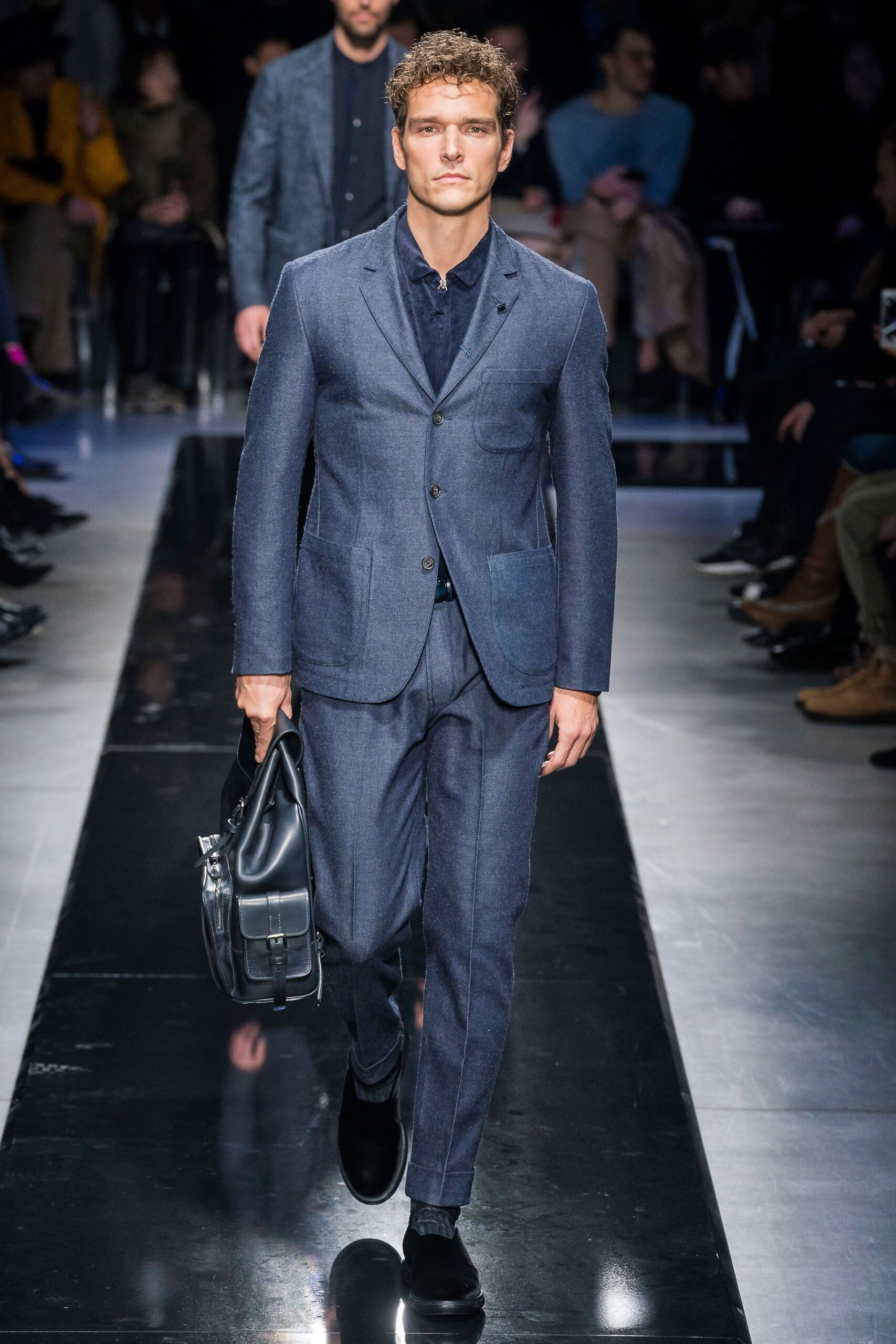 blue tailored suit with leather bag