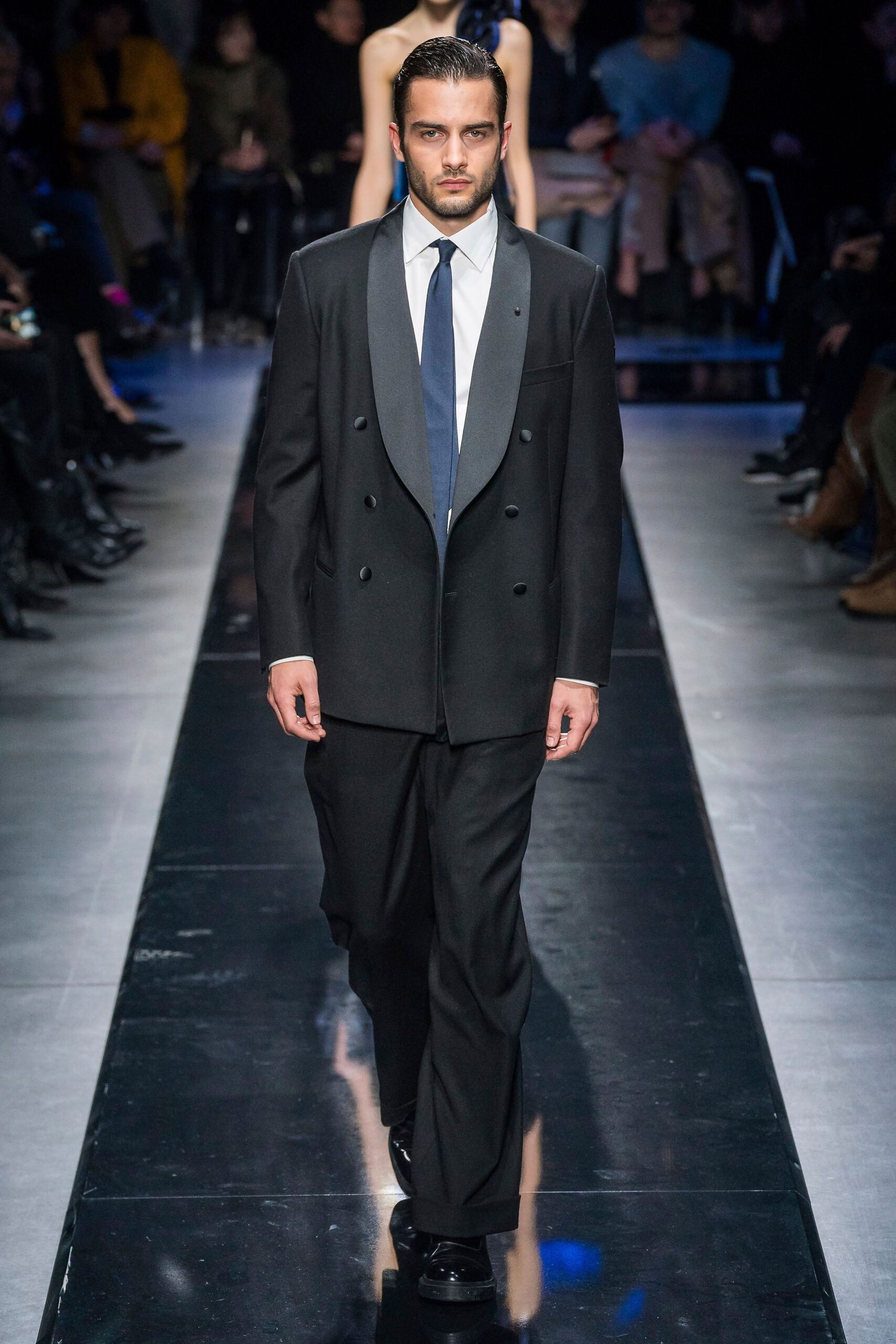black tailored suit with blue tie