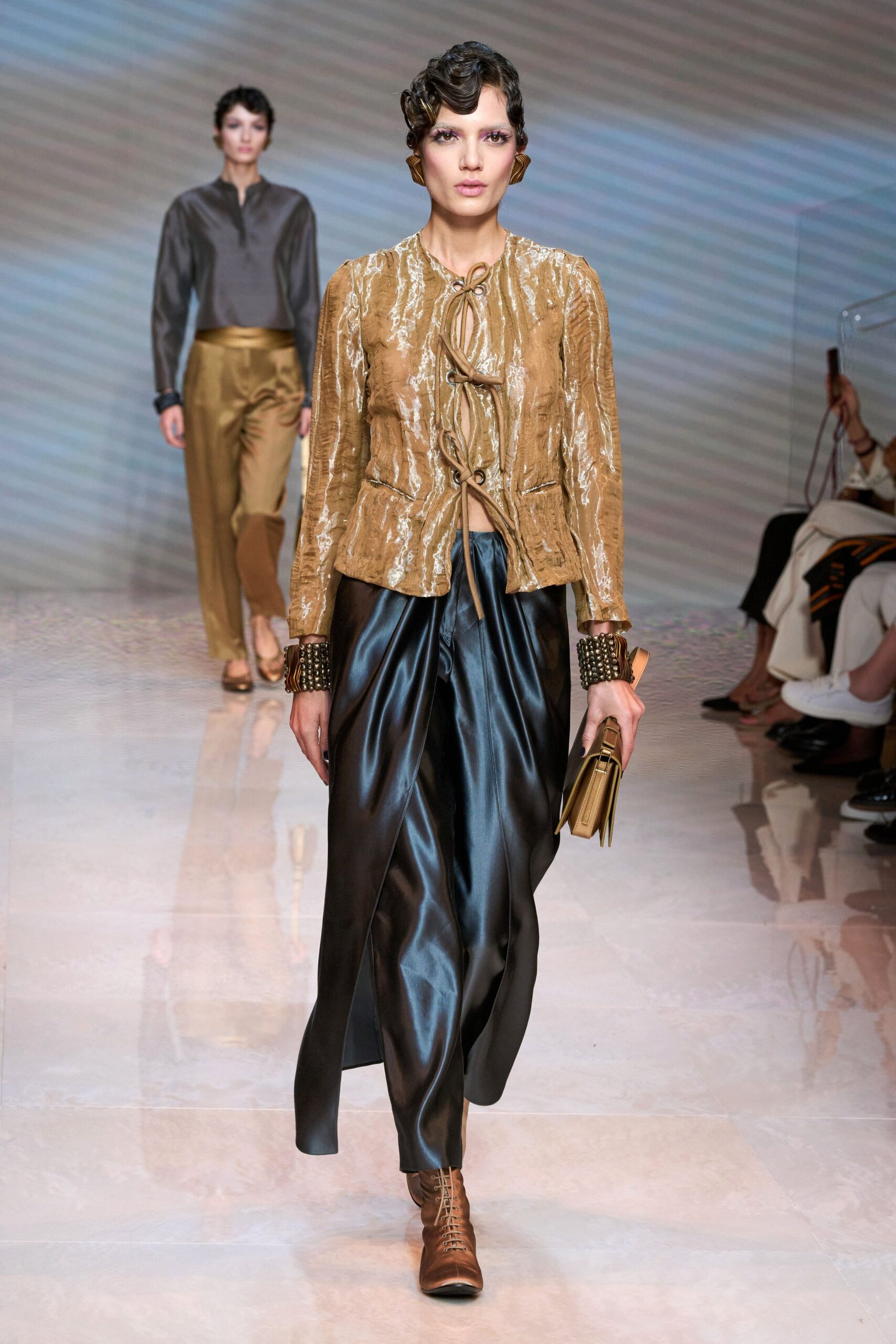 gold silk jacket with black skirt