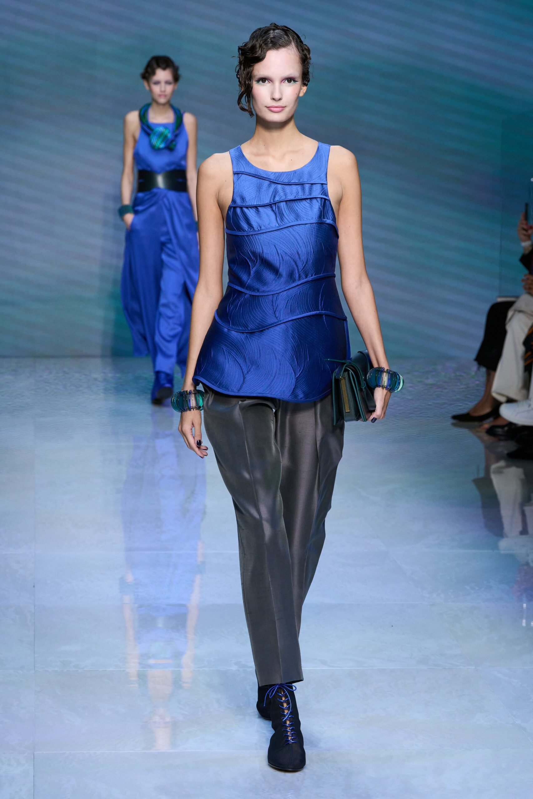 blue silk fitted top with gray pants