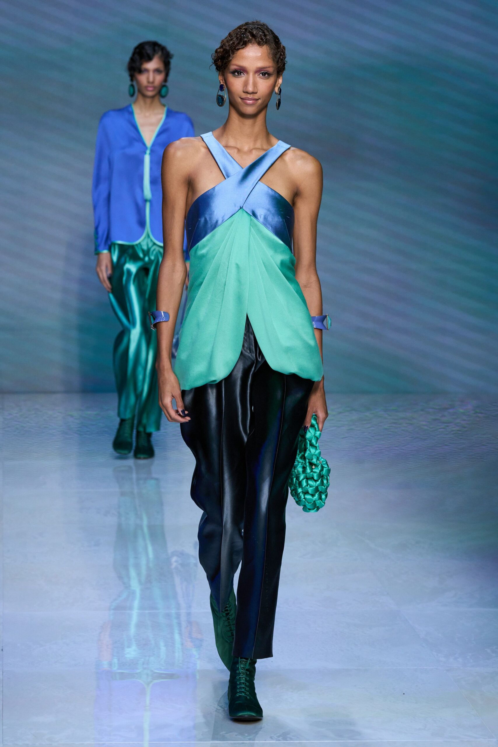 blue green fitted top with black pants