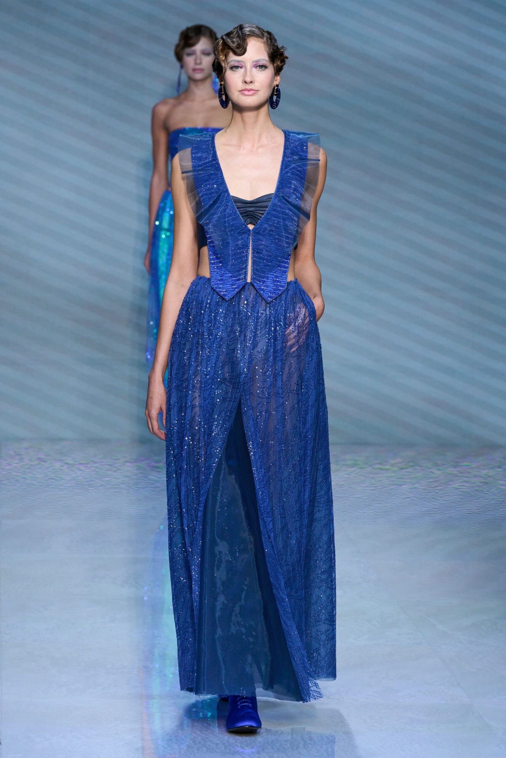 blue silk sleeveless v-neck fitted layered pleated gown