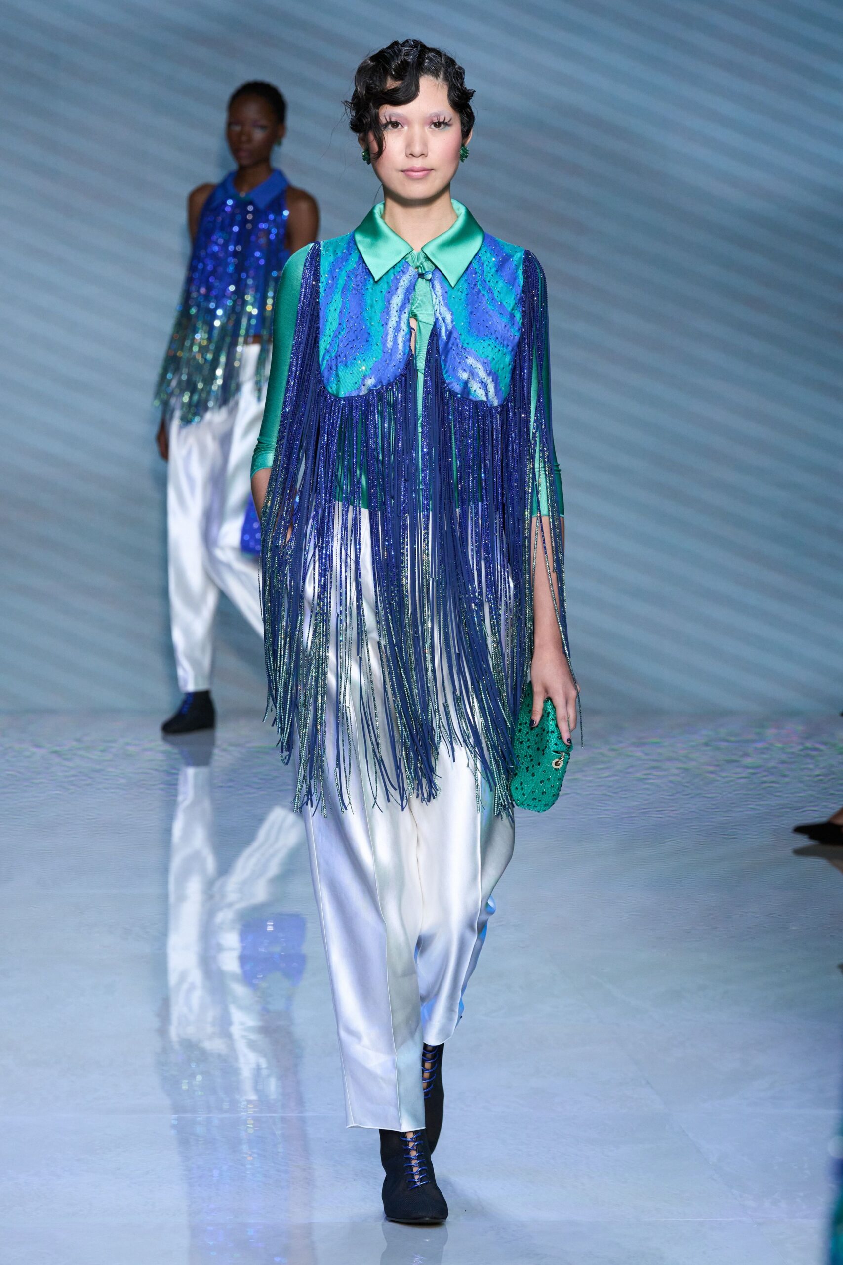 blue green fringed top with white pants