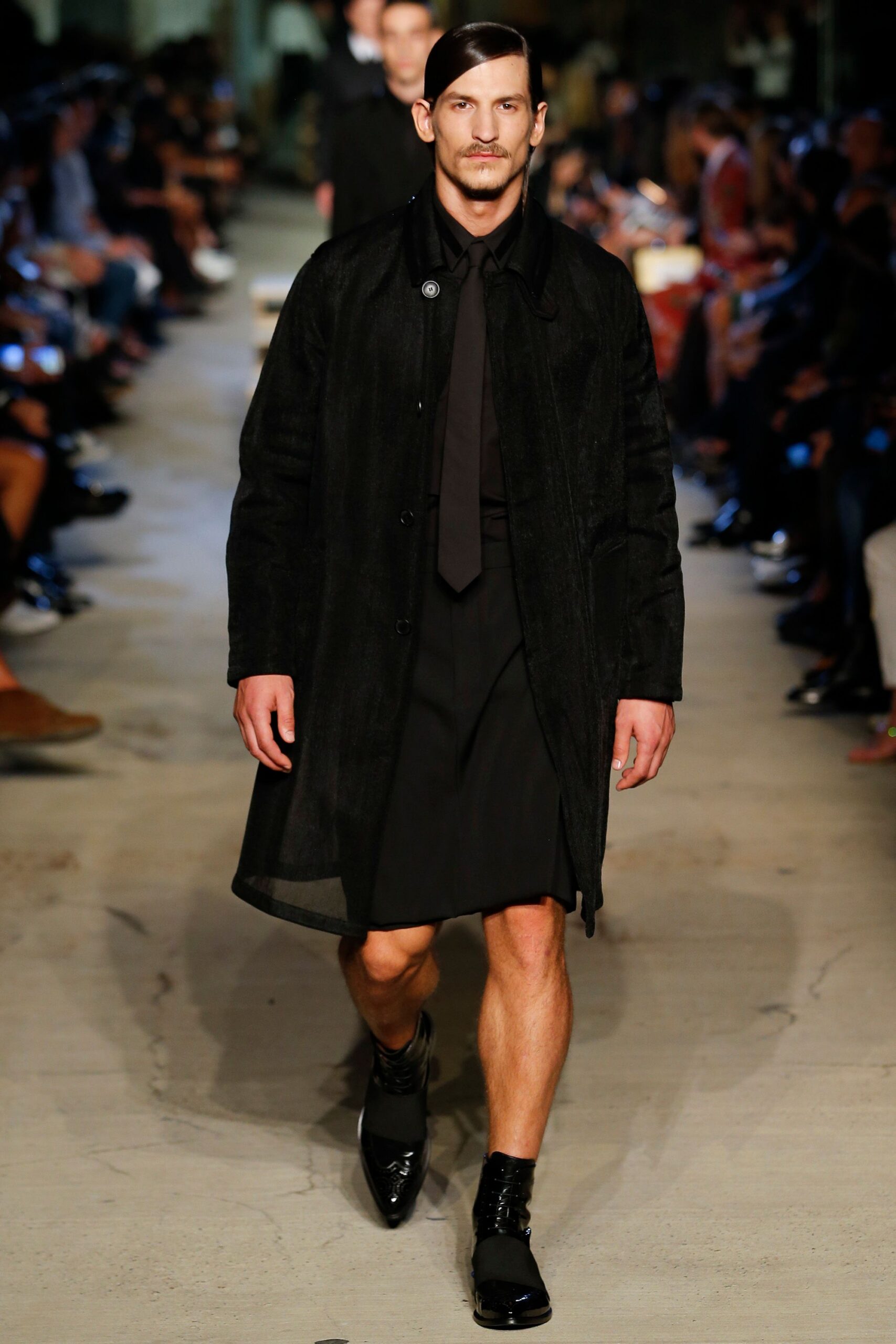 black coat with pleated skirt