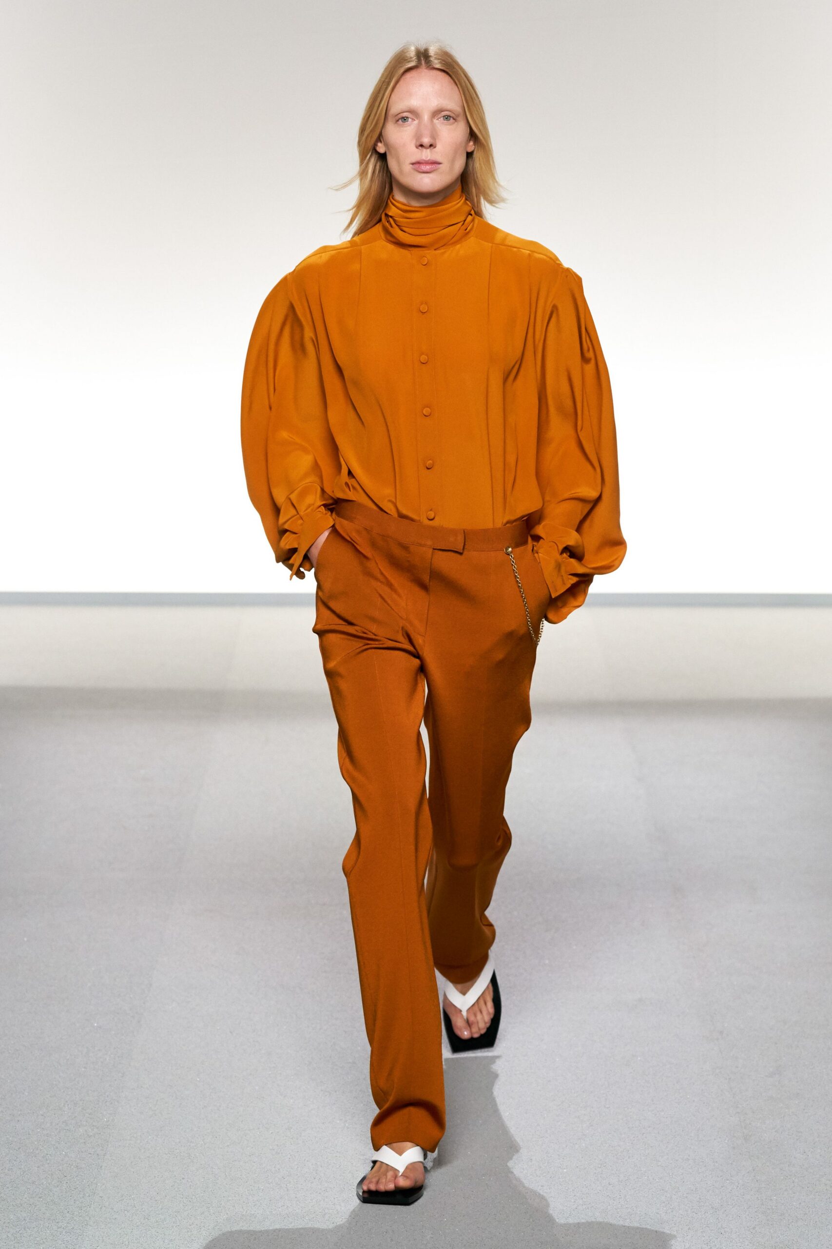 orange cotton long-sleeve turtleneck relaxed buttoned pleated blouse