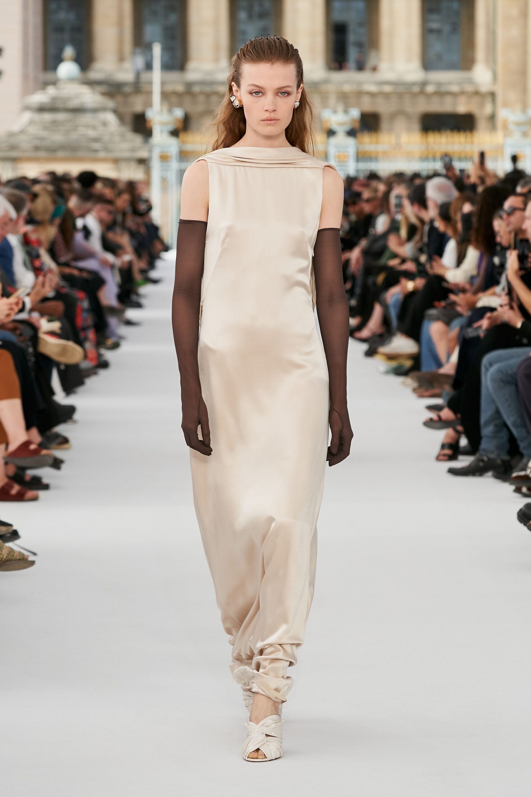 beige silk sleeveless high-neck fitted draped flowing gown