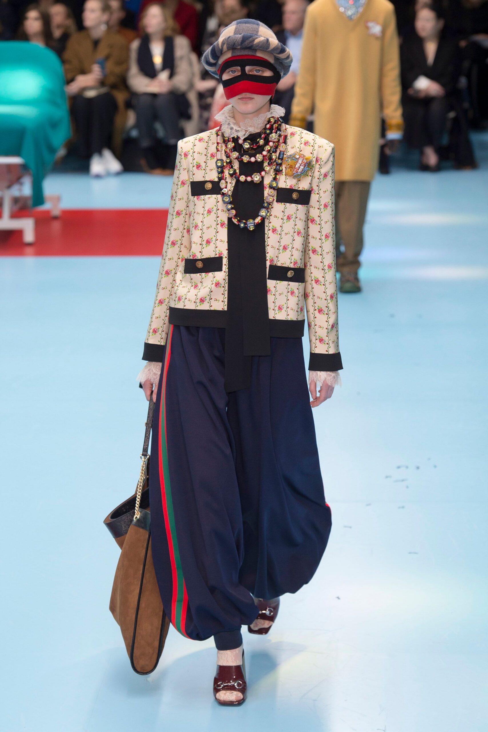 embroidered beige jacket with black top