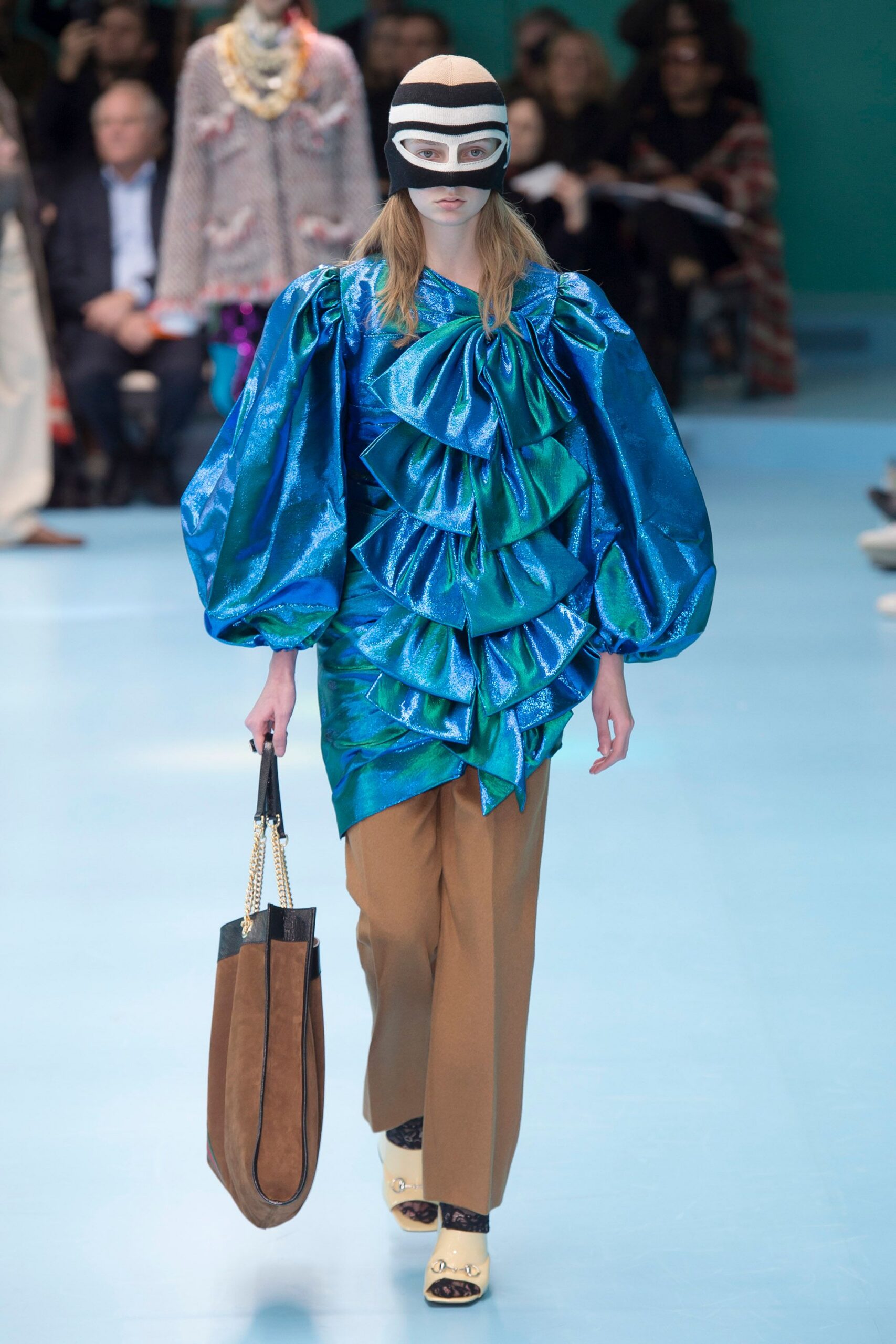 blue ruffled top with brown pants