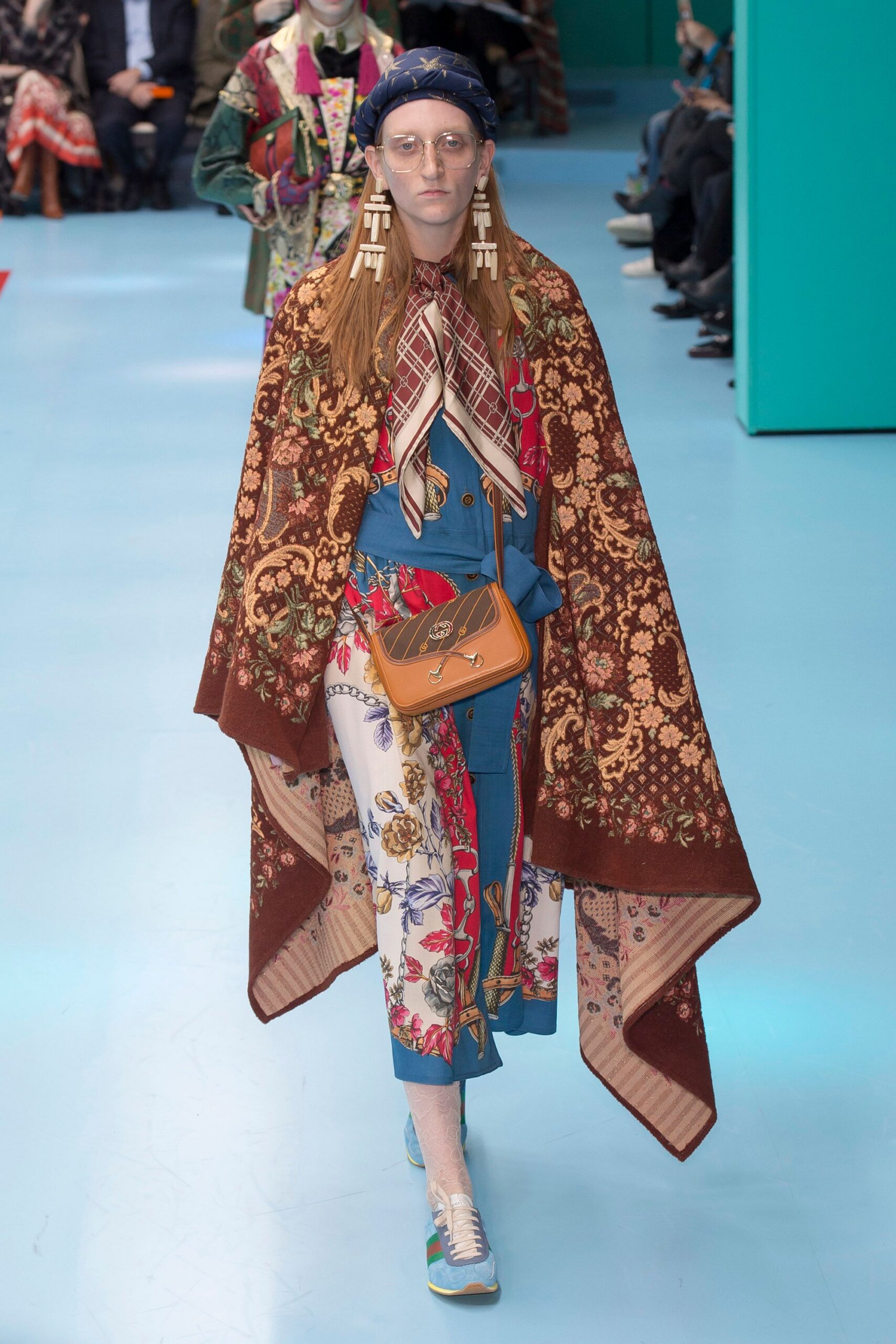 multi-colored cape and blue dress