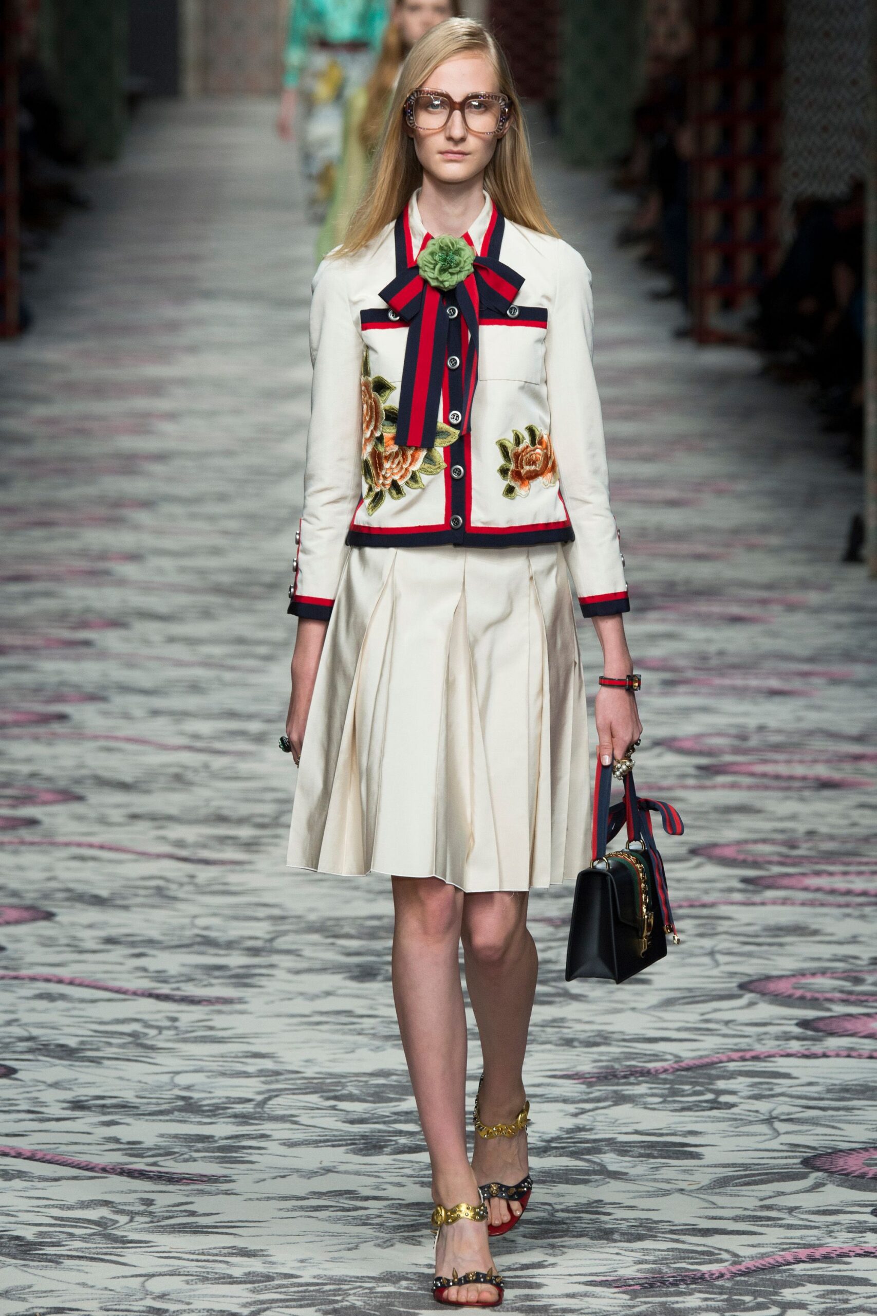 embroidered white jacket and beige skirt
