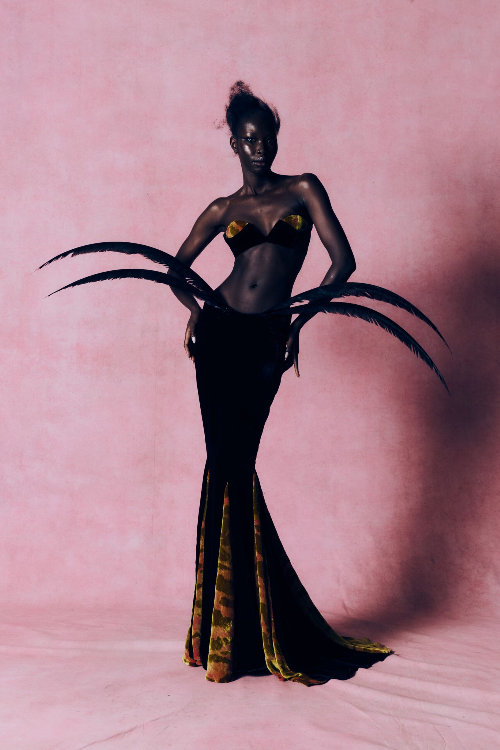 black velvet gown with feather accessory