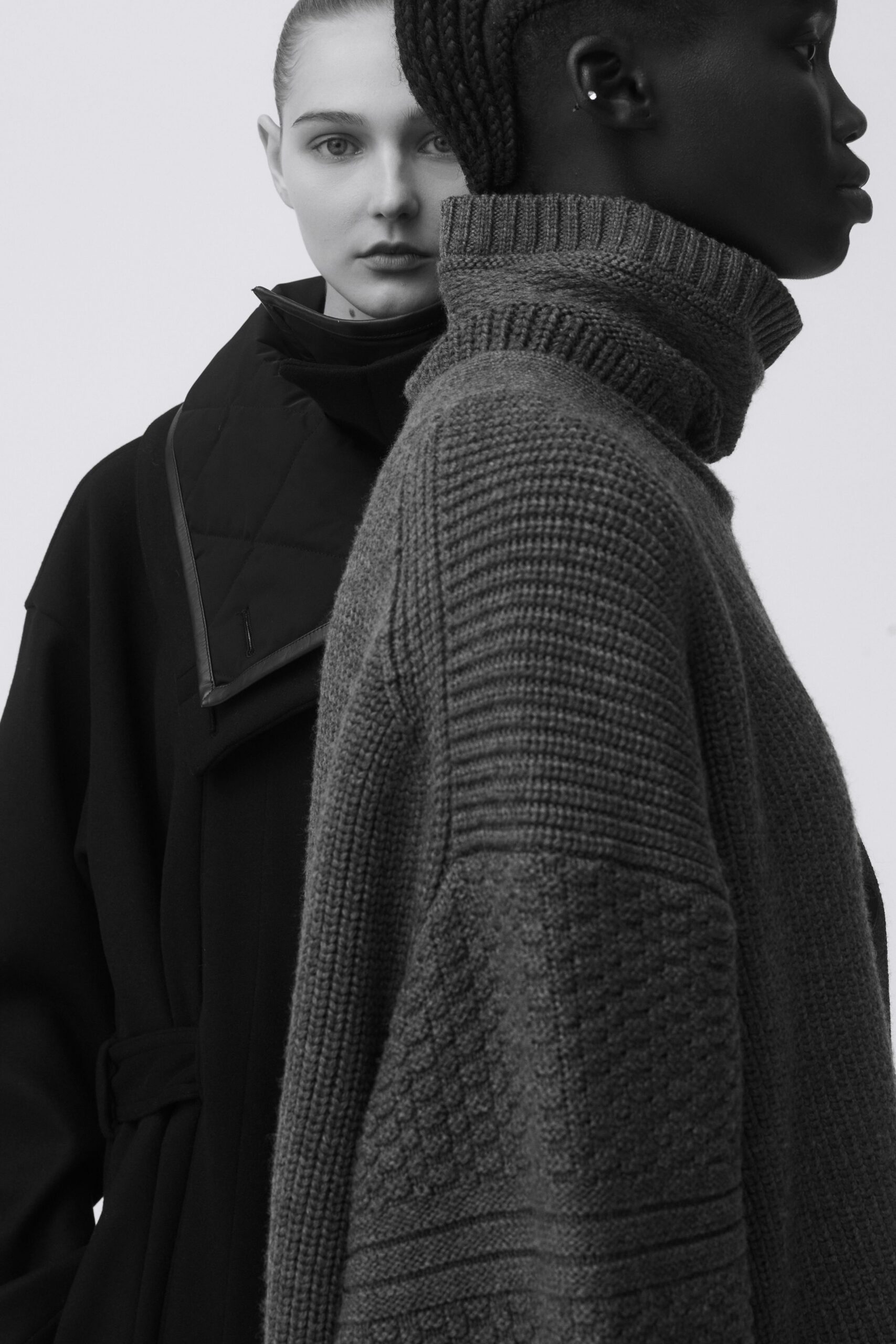 black wool coat and gray knit sweater