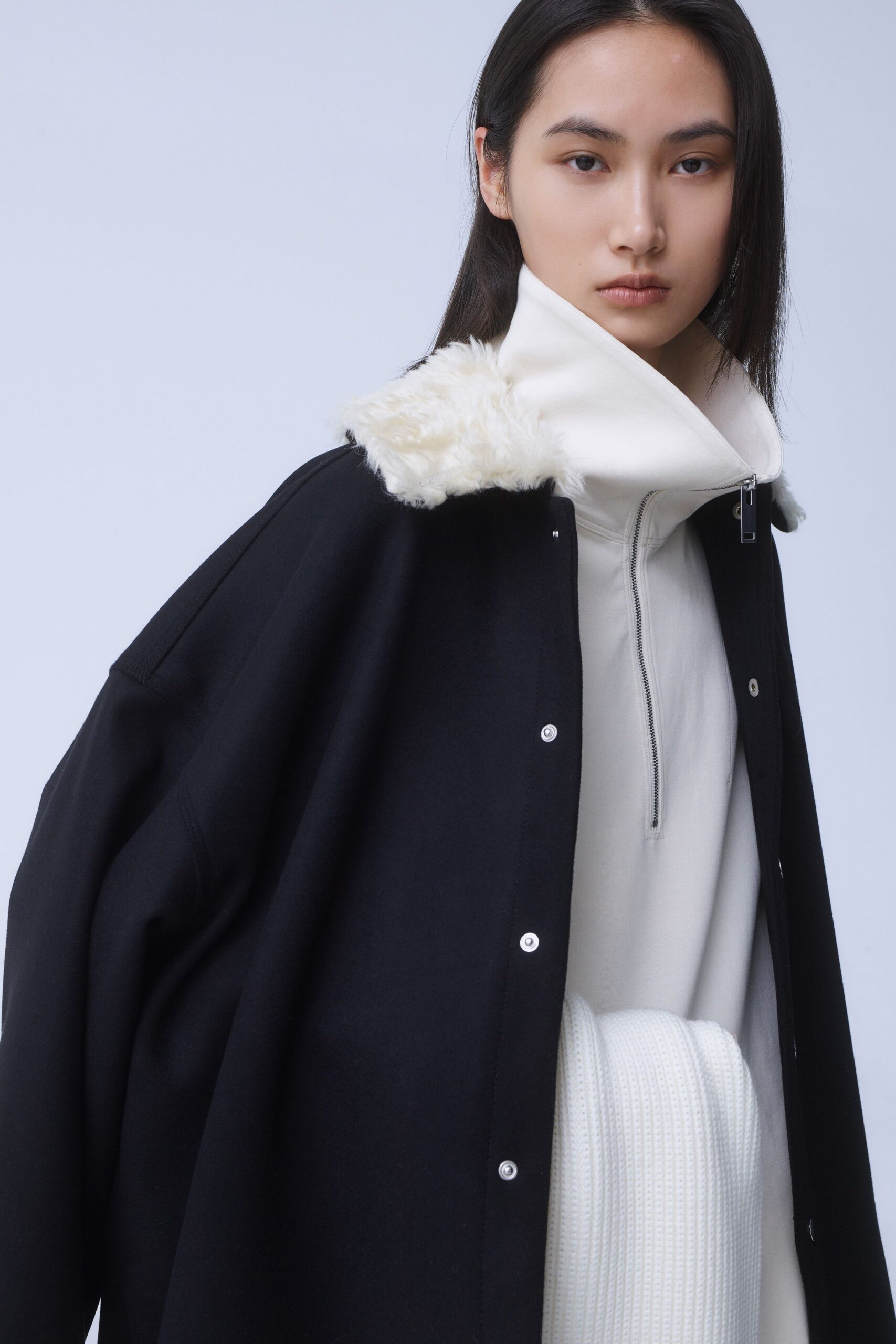 black coat and white top