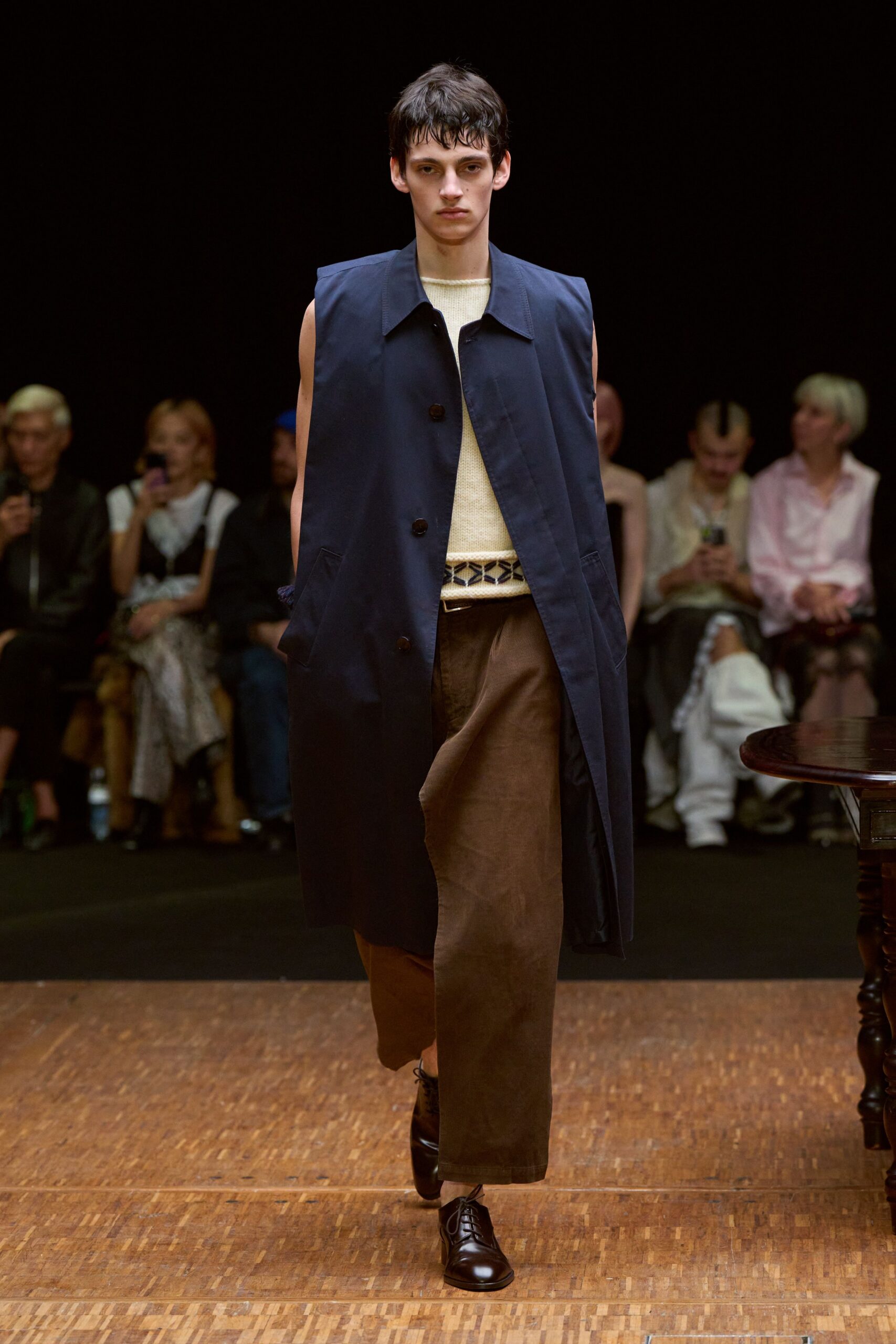 navy coat beige top brown pants