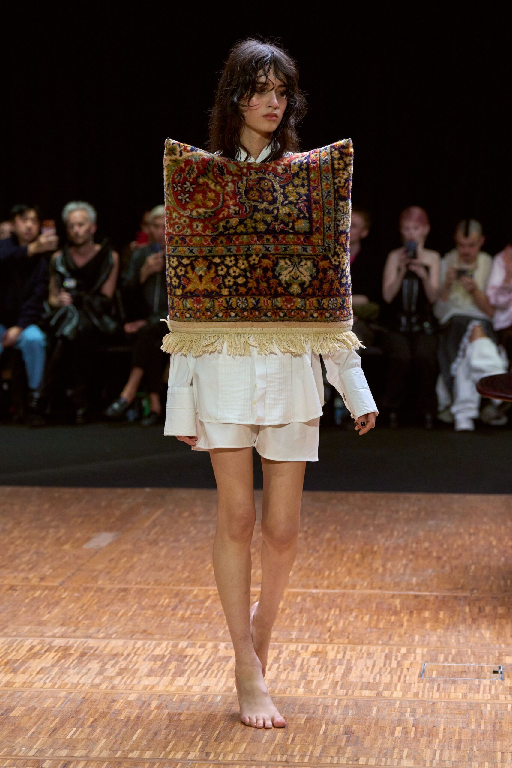 white shirt and shorts with multi-colored cape