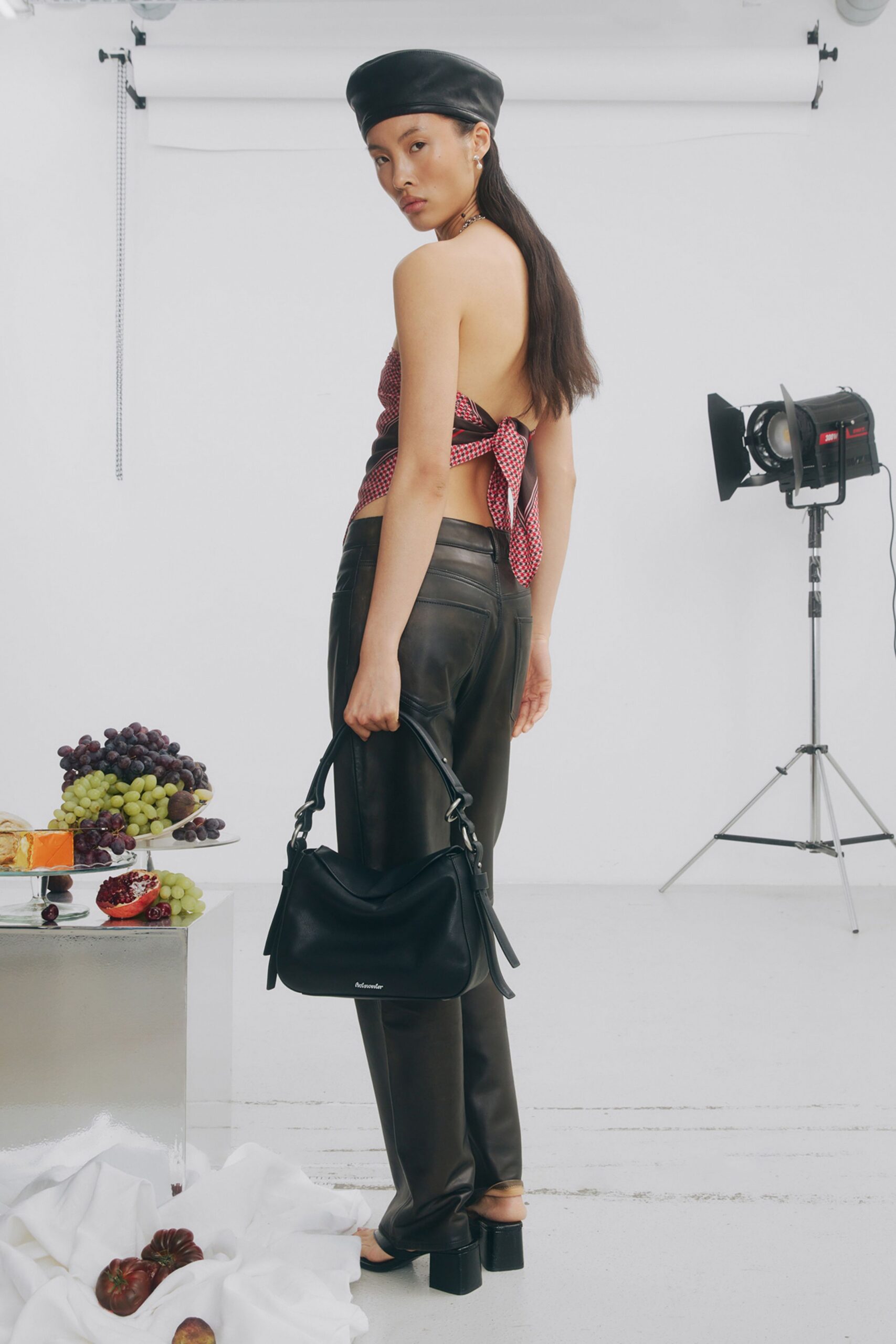 red polka-dot sleeveless top with black leather pants