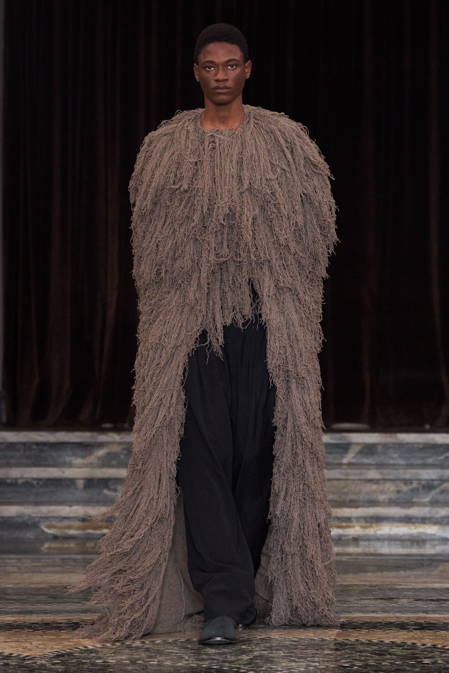 brown fringed coat with black pants