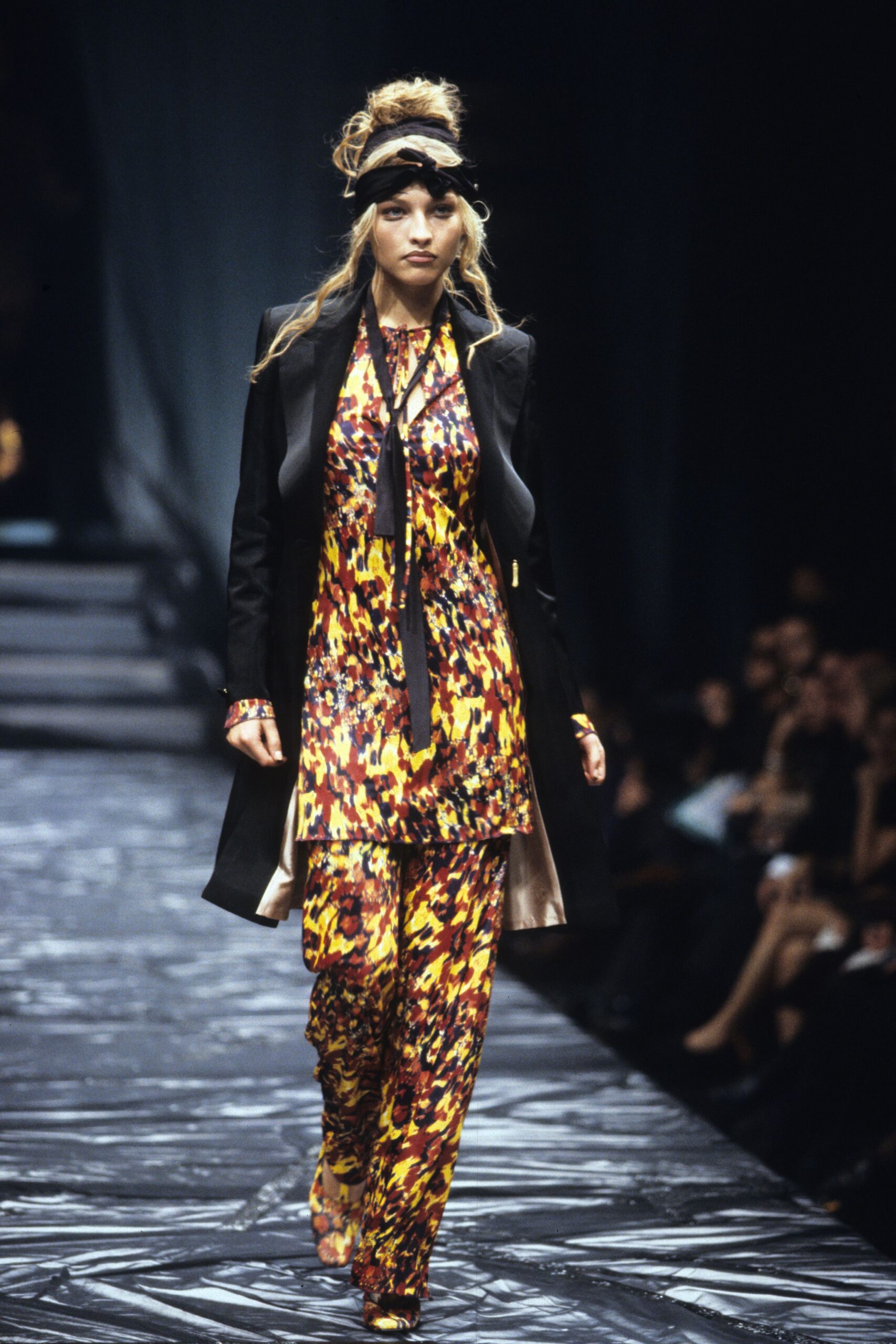 black coat over printed dress and pants