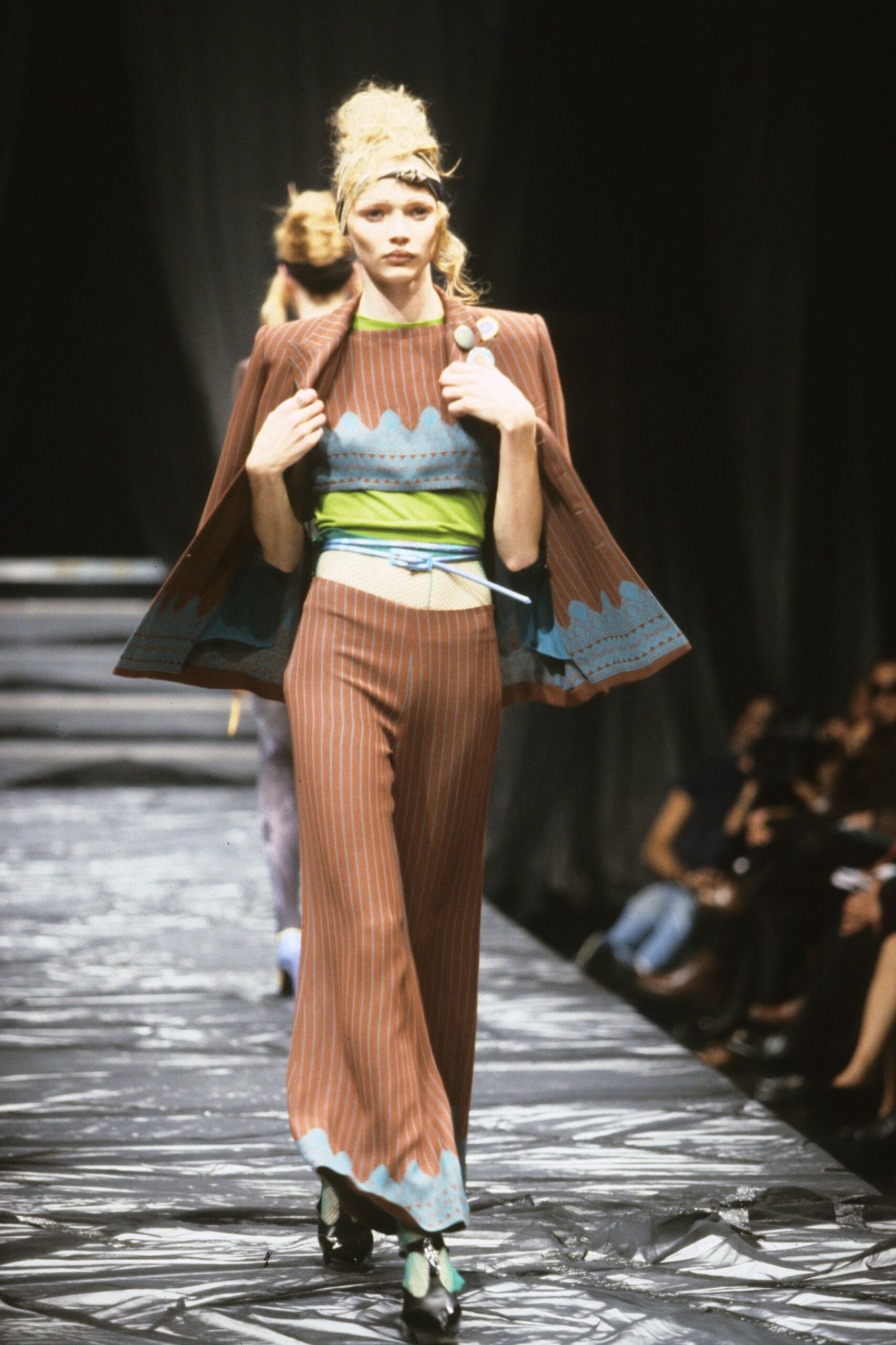 brown cape with striped top and wide-leg pants