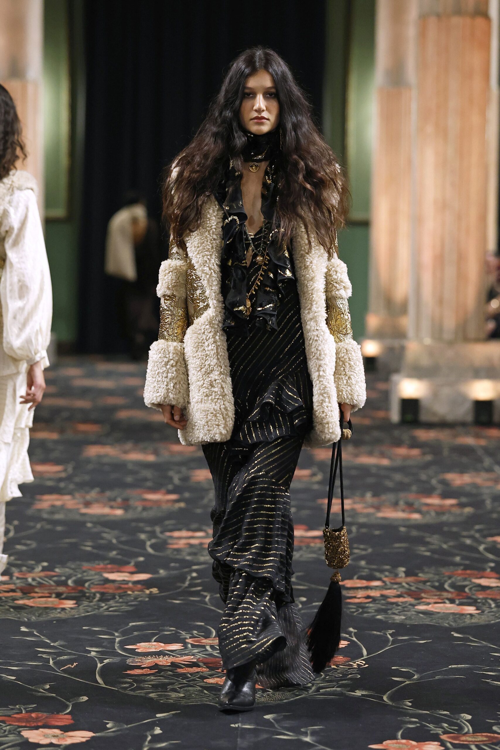 beige fur coat and black ruffled dress