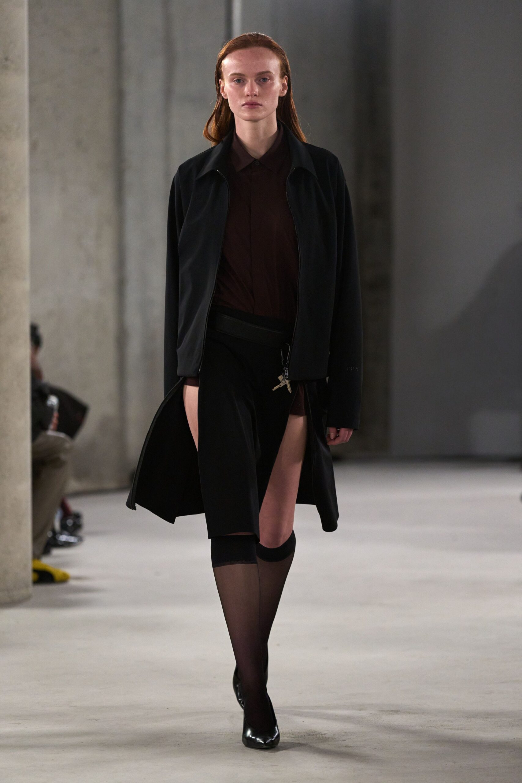 black jacket brown shirt black skirt