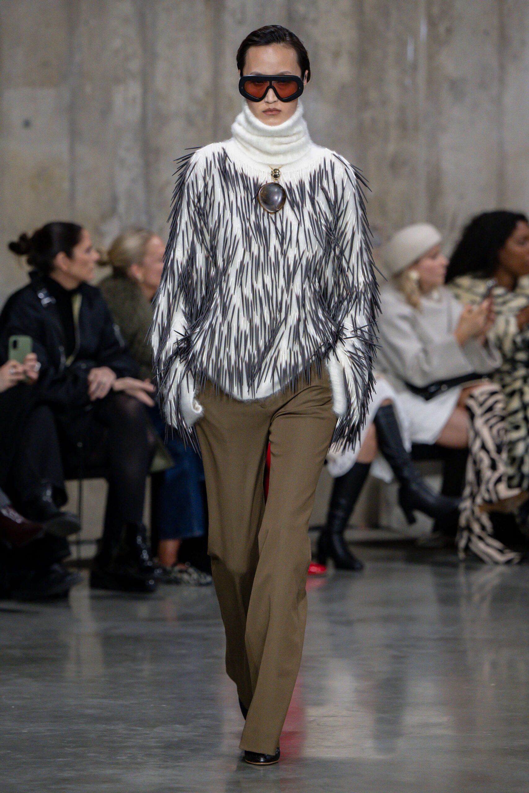 fringed white sweater with brown pants