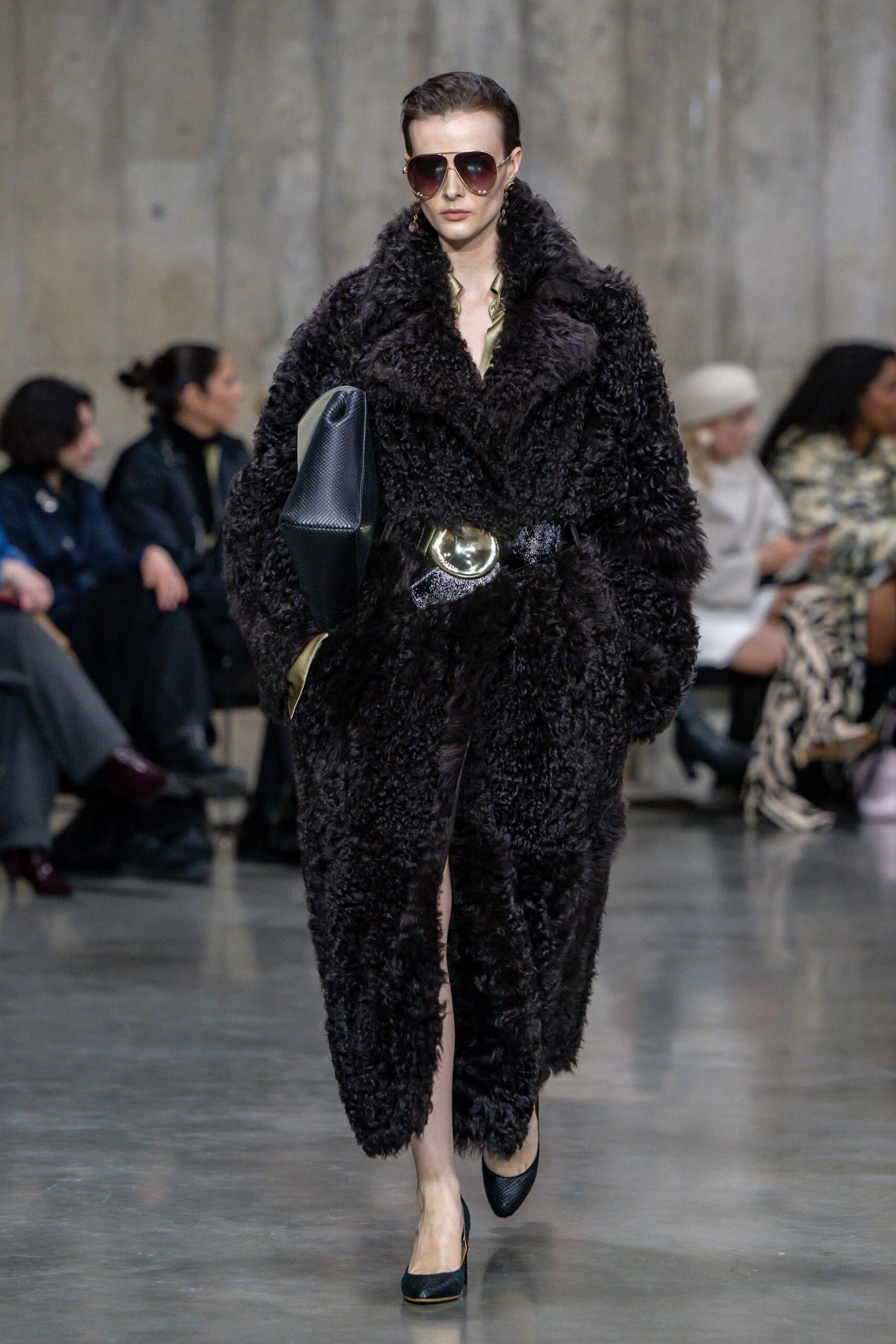 black faux-fur coat with sunglasses