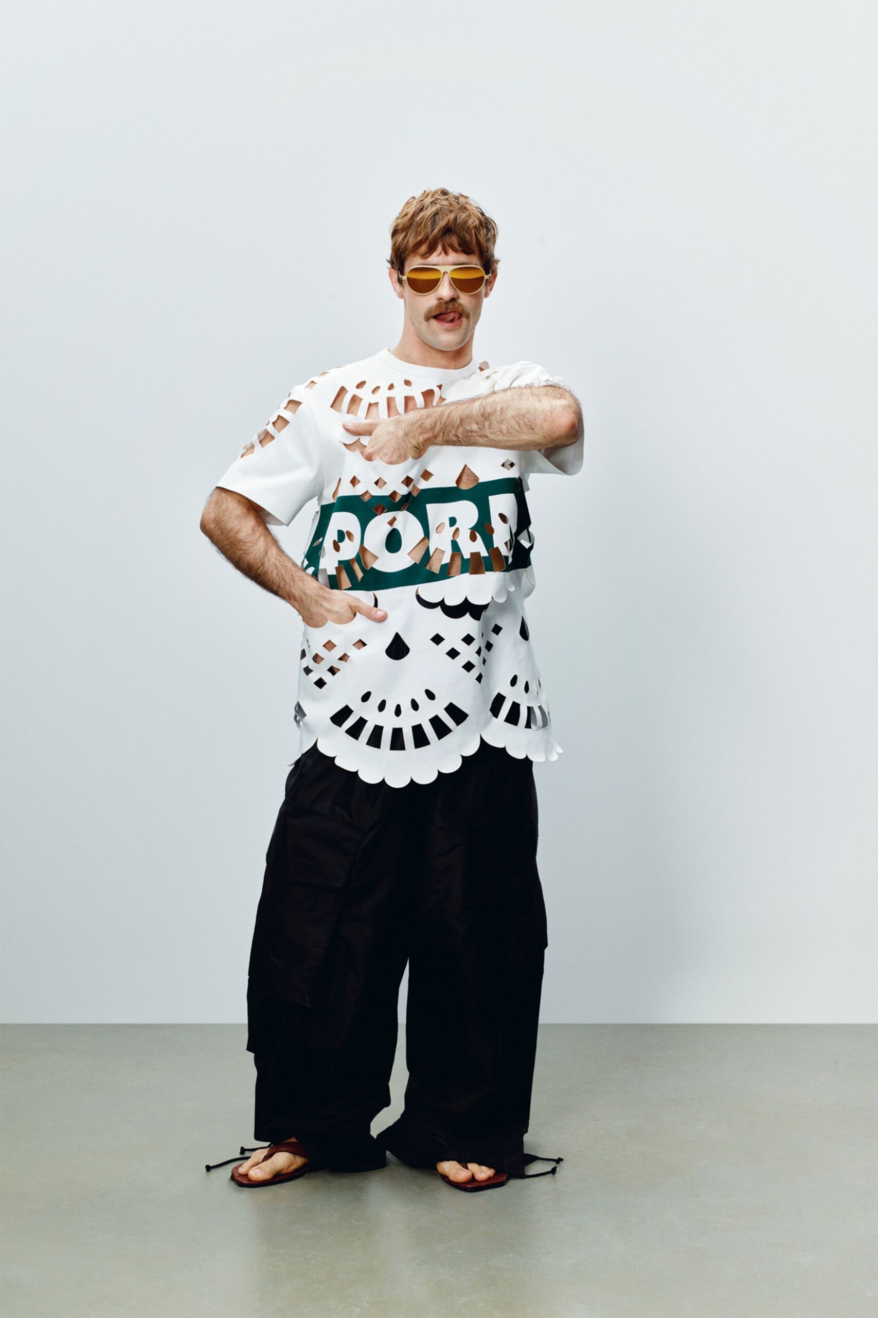 white cutout t-shirt with black cargo pants