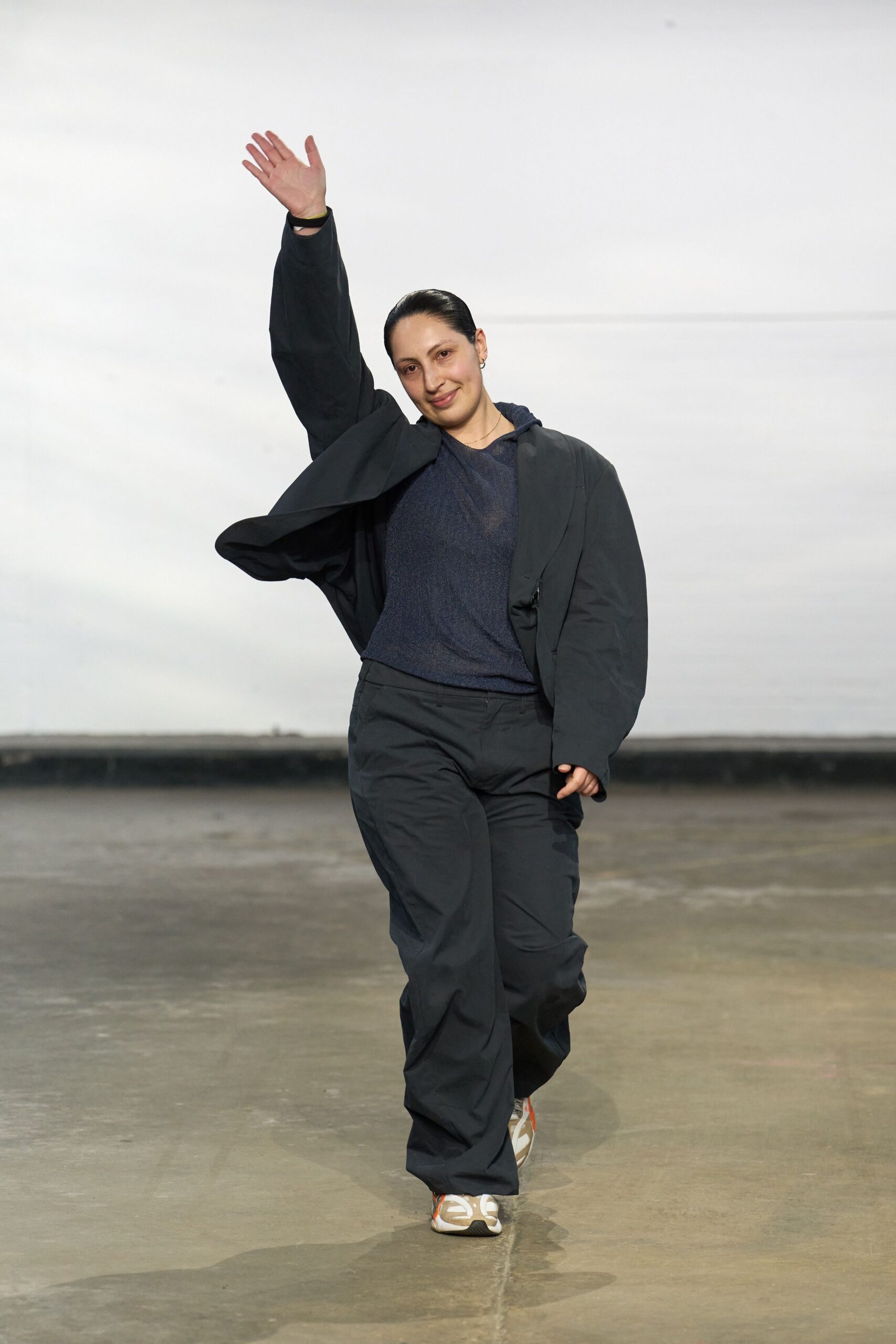 black jacket blue top relaxed pants