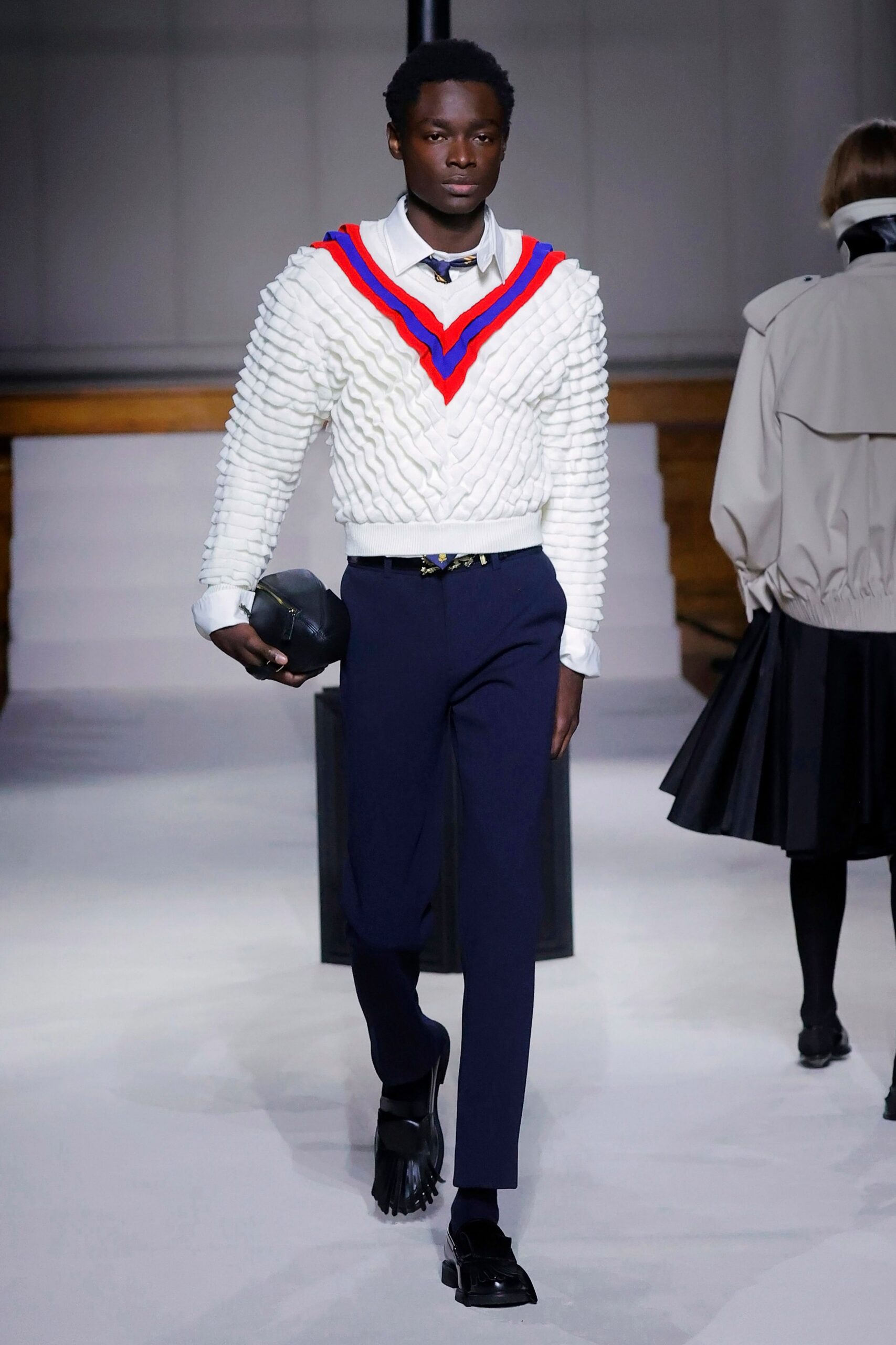 white pleated sweater with blue pants