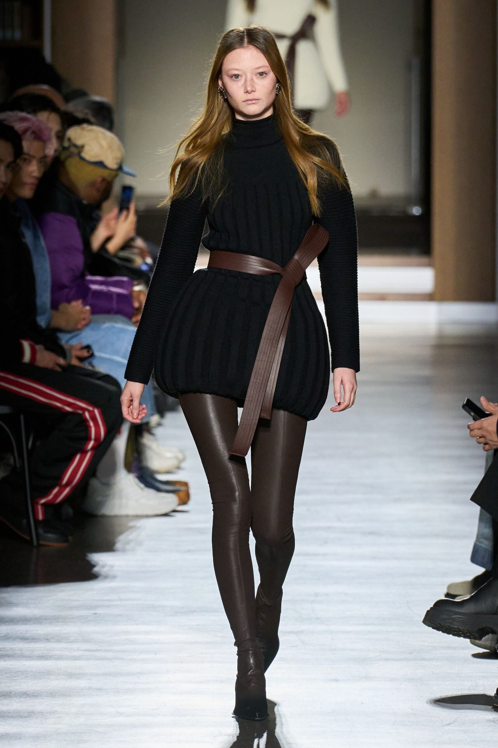 black knit turtleneck top with brown leather pants