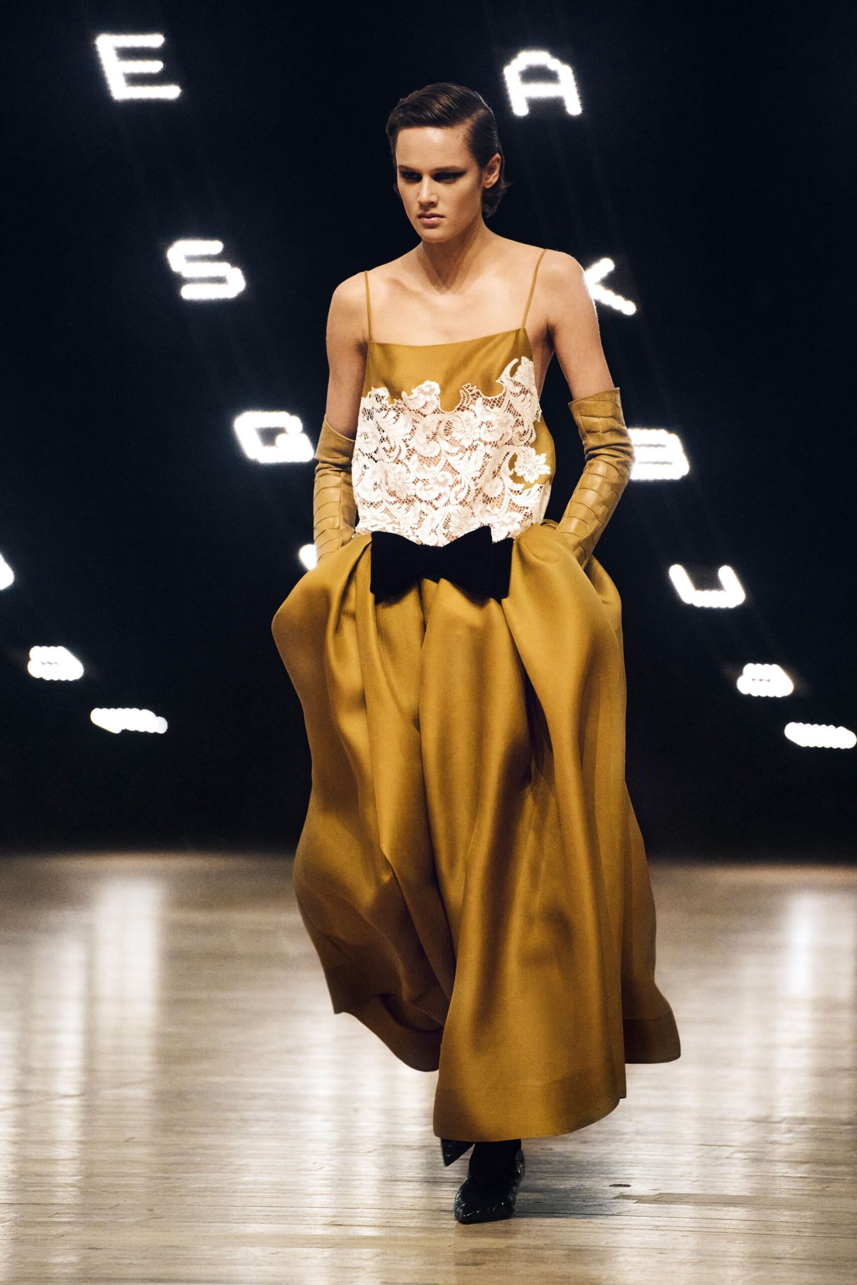gold silk sleeveless v-neck fitted pleated layered gown